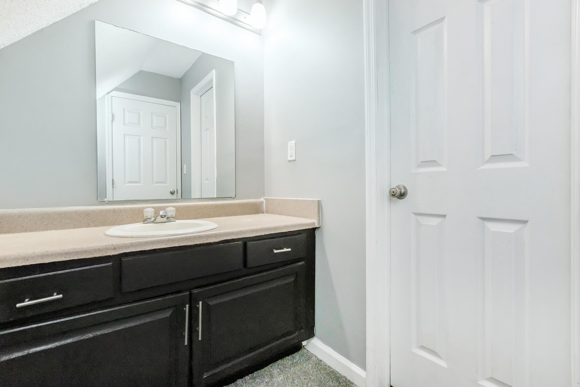 a kitchen with a sink and a mirror