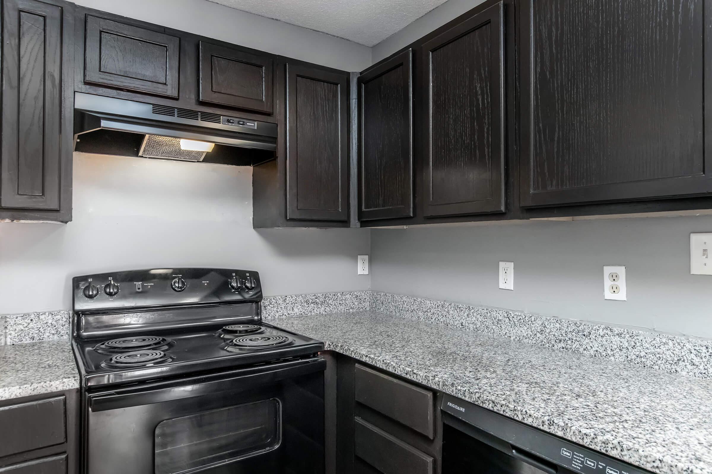 a stove top oven sitting inside of a kitchen