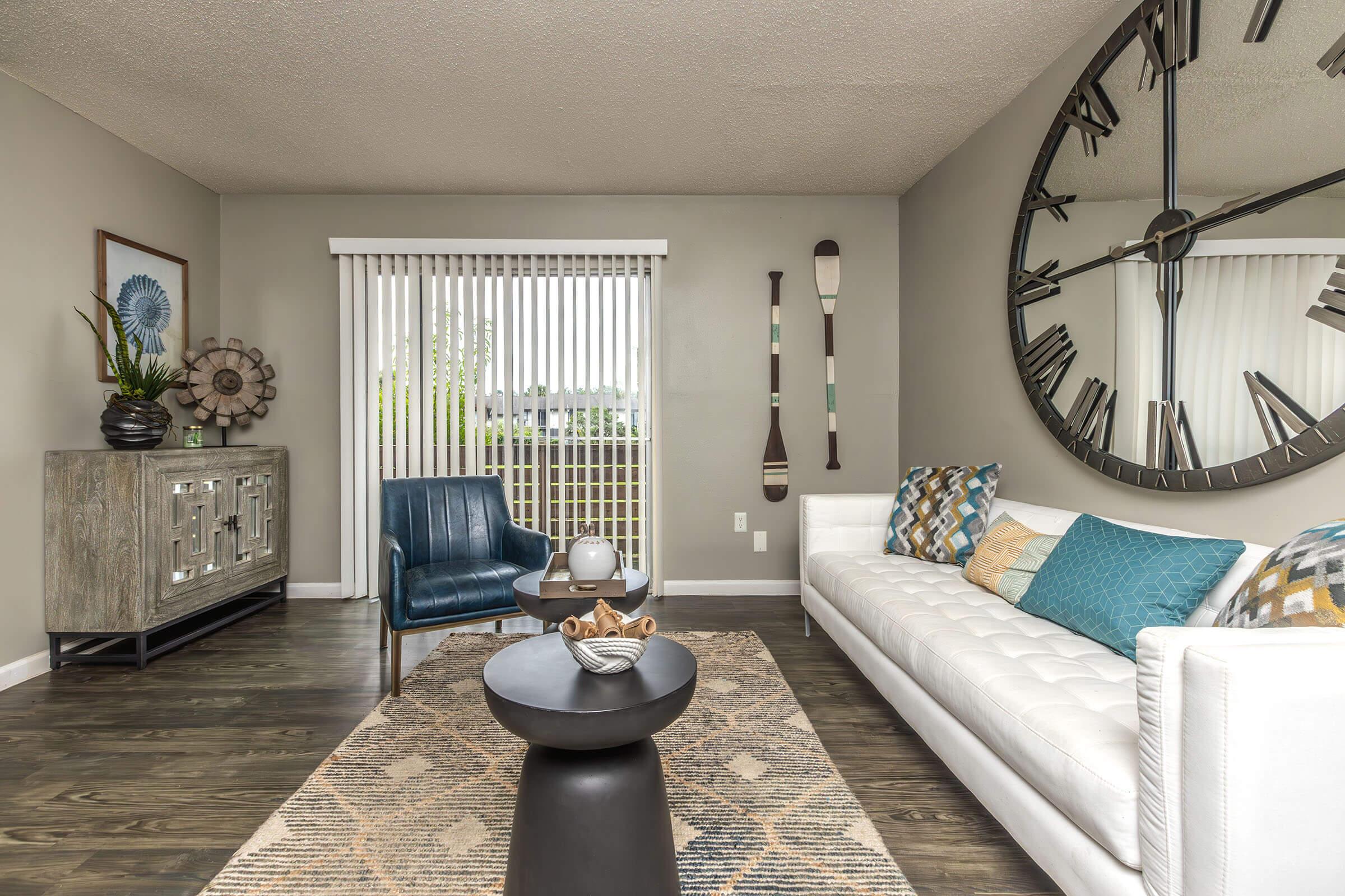 a living room filled with furniture and a clock