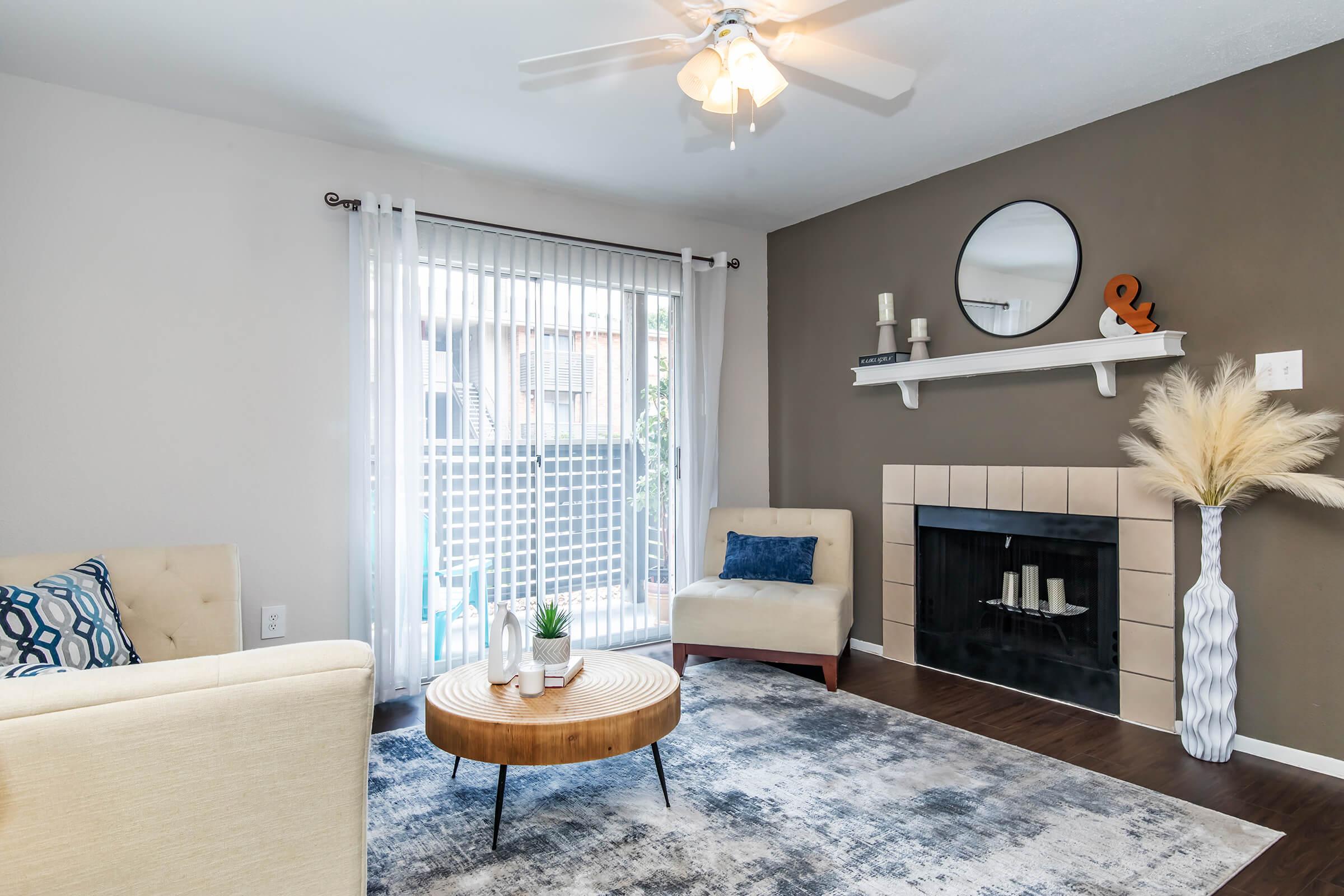 a living room filled with furniture and a large window