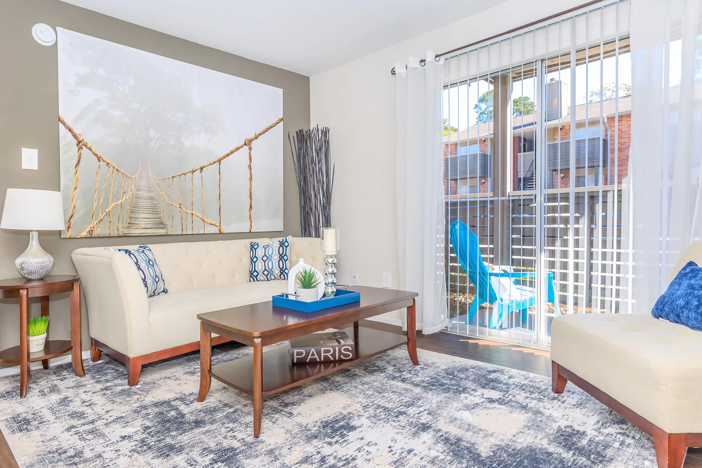 a living room filled with furniture and a large window