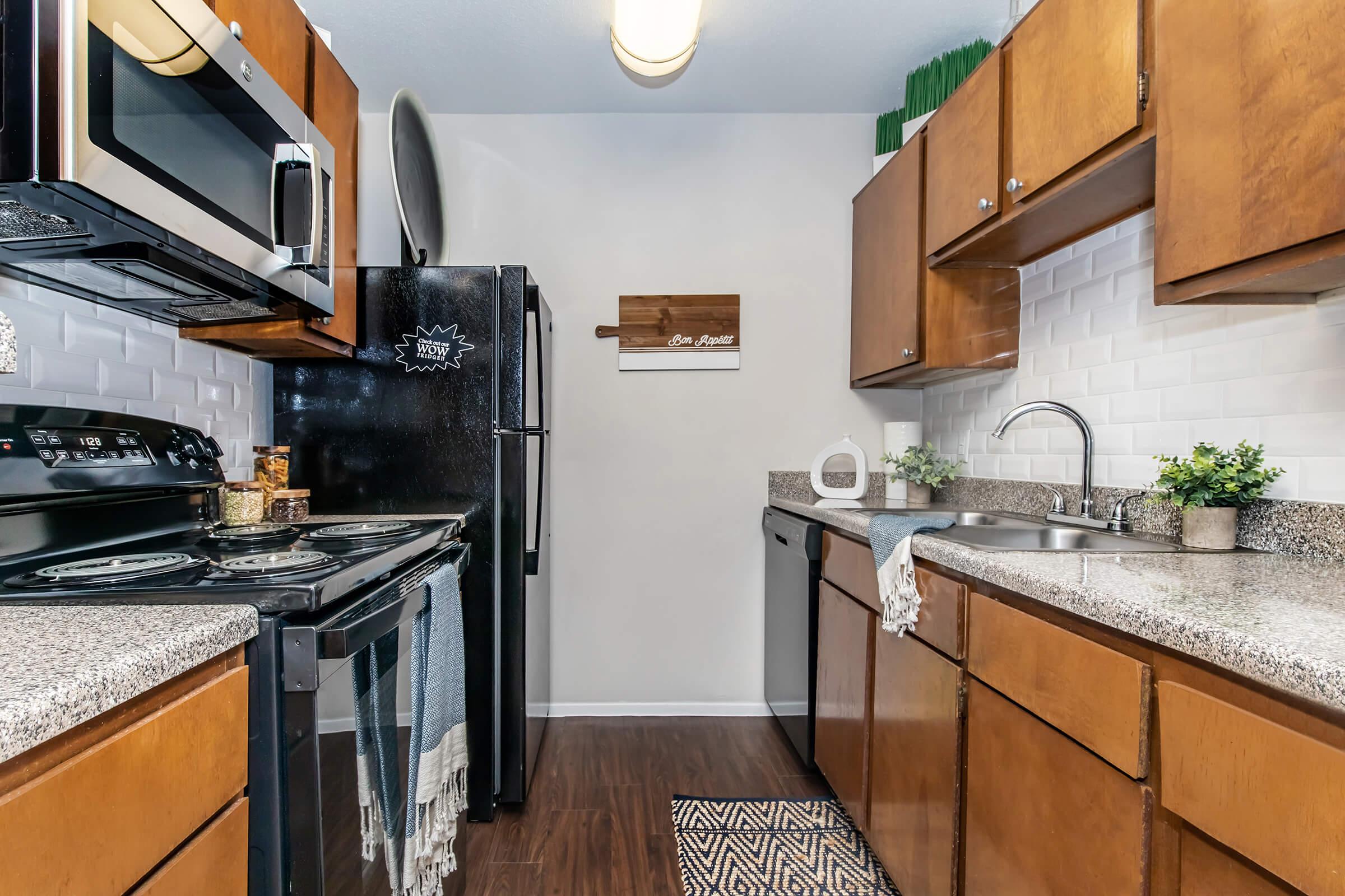 a modern kitchen with stainless steel appliances and wooden cabinets