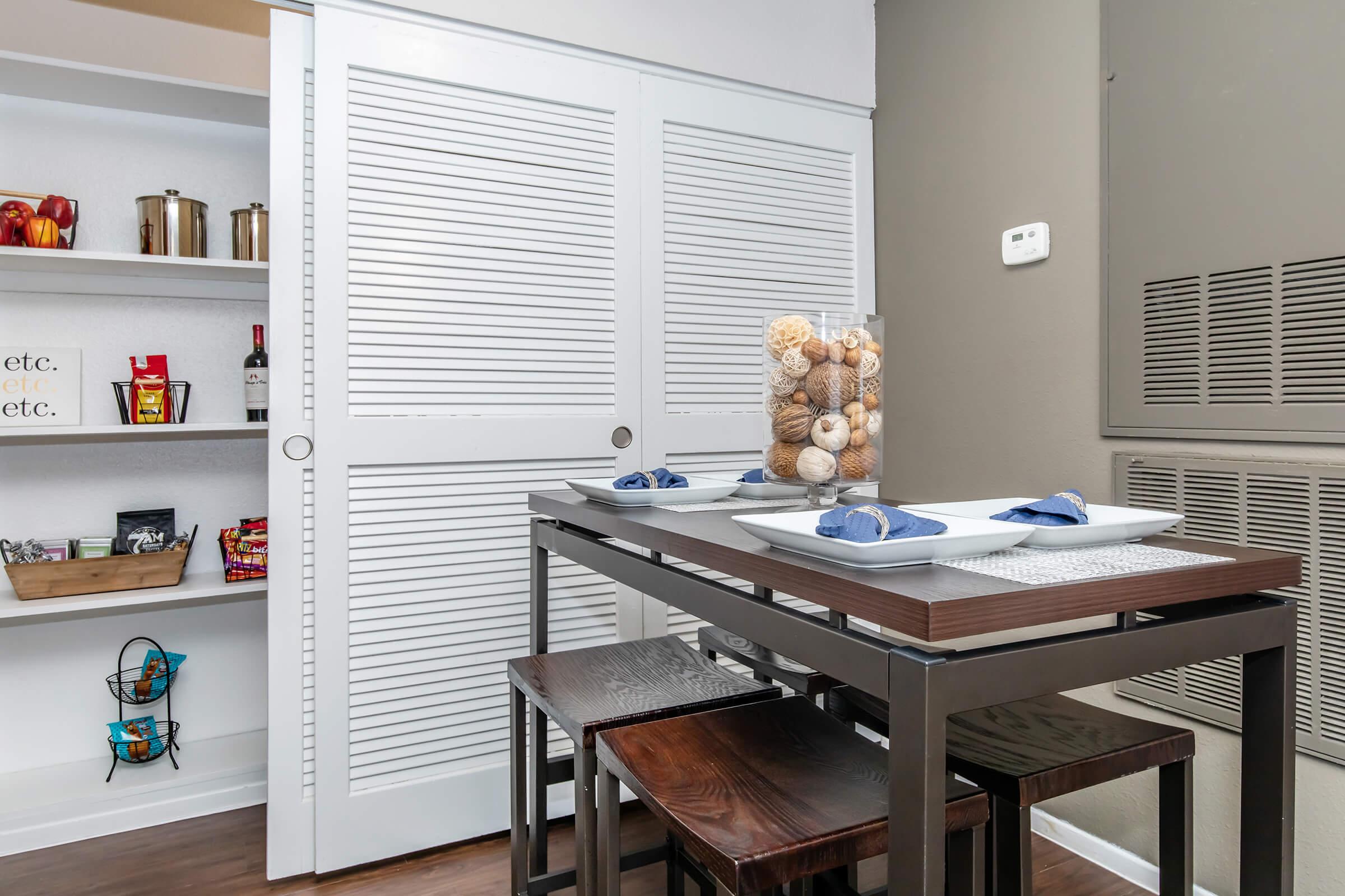 a kitchen with a table in front of a window