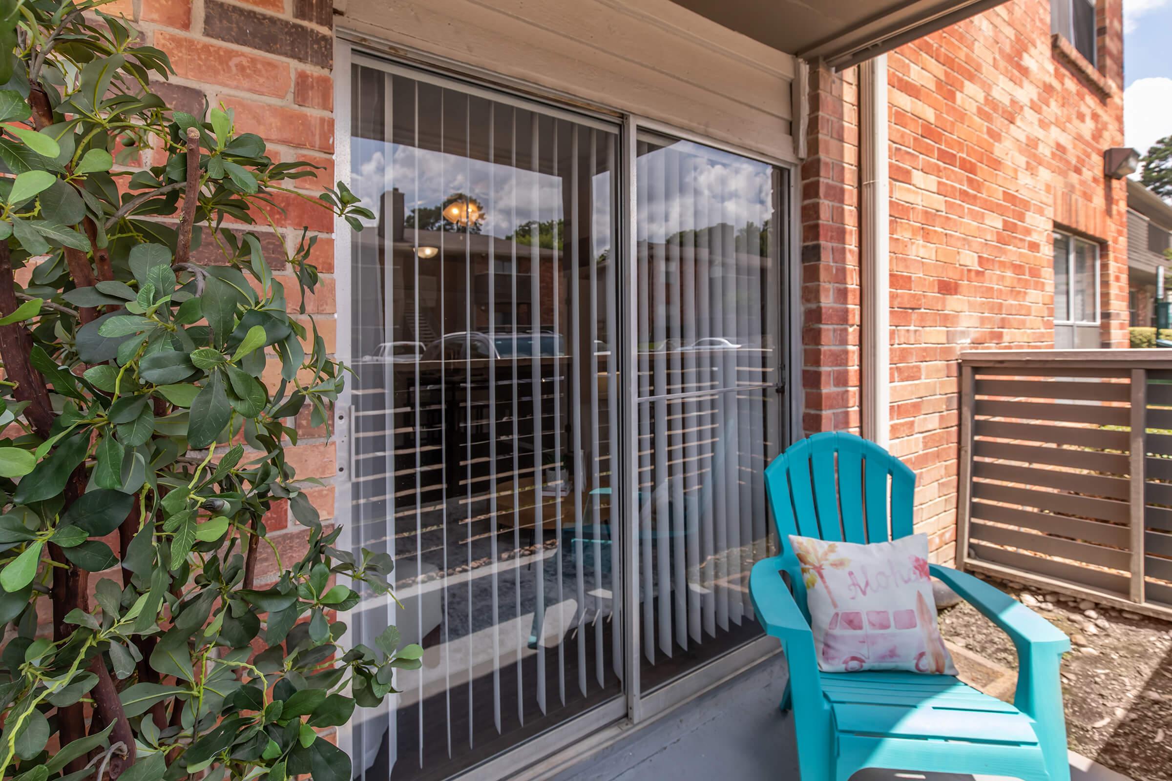 a chair sitting in front of a brick building