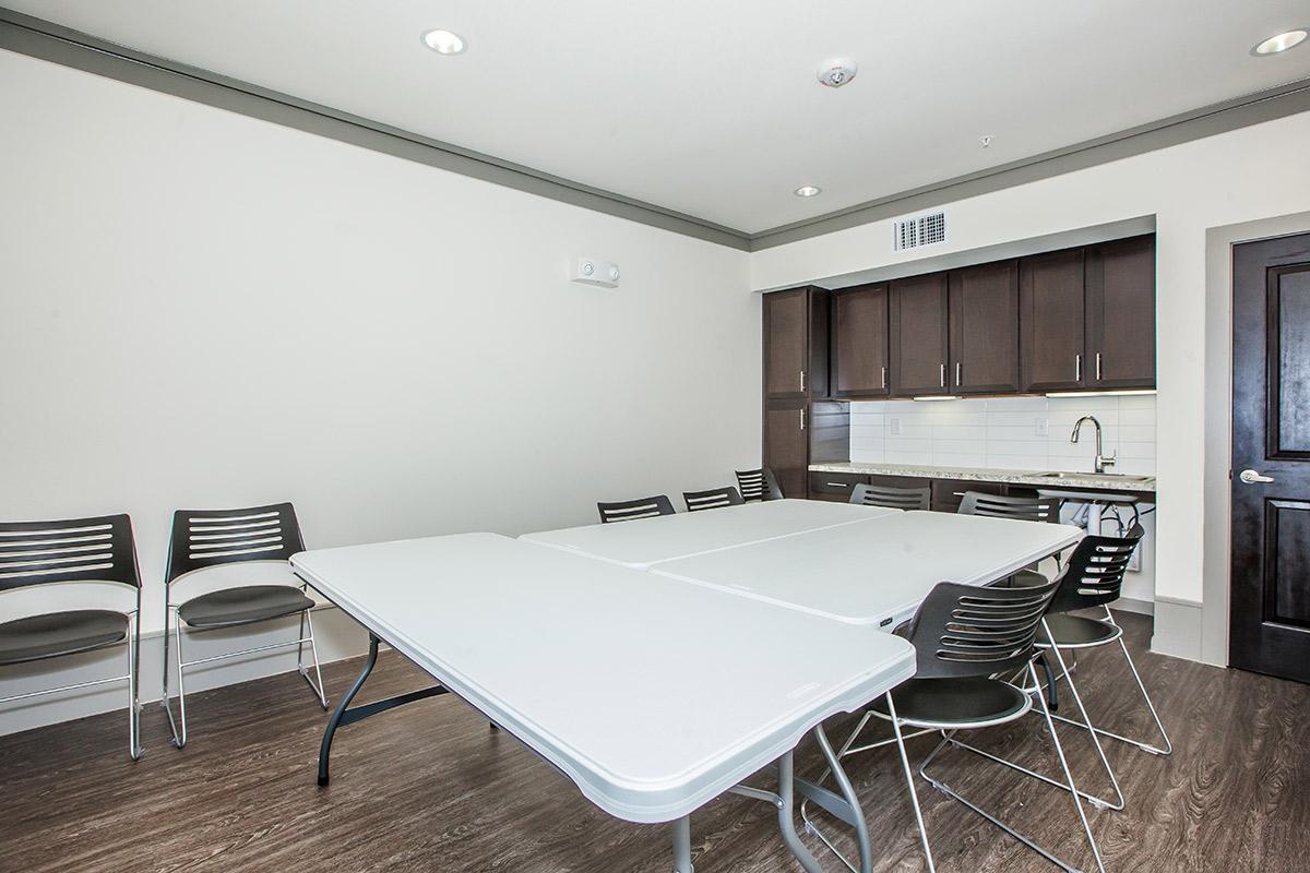 a bedroom with a desk and chair in a room