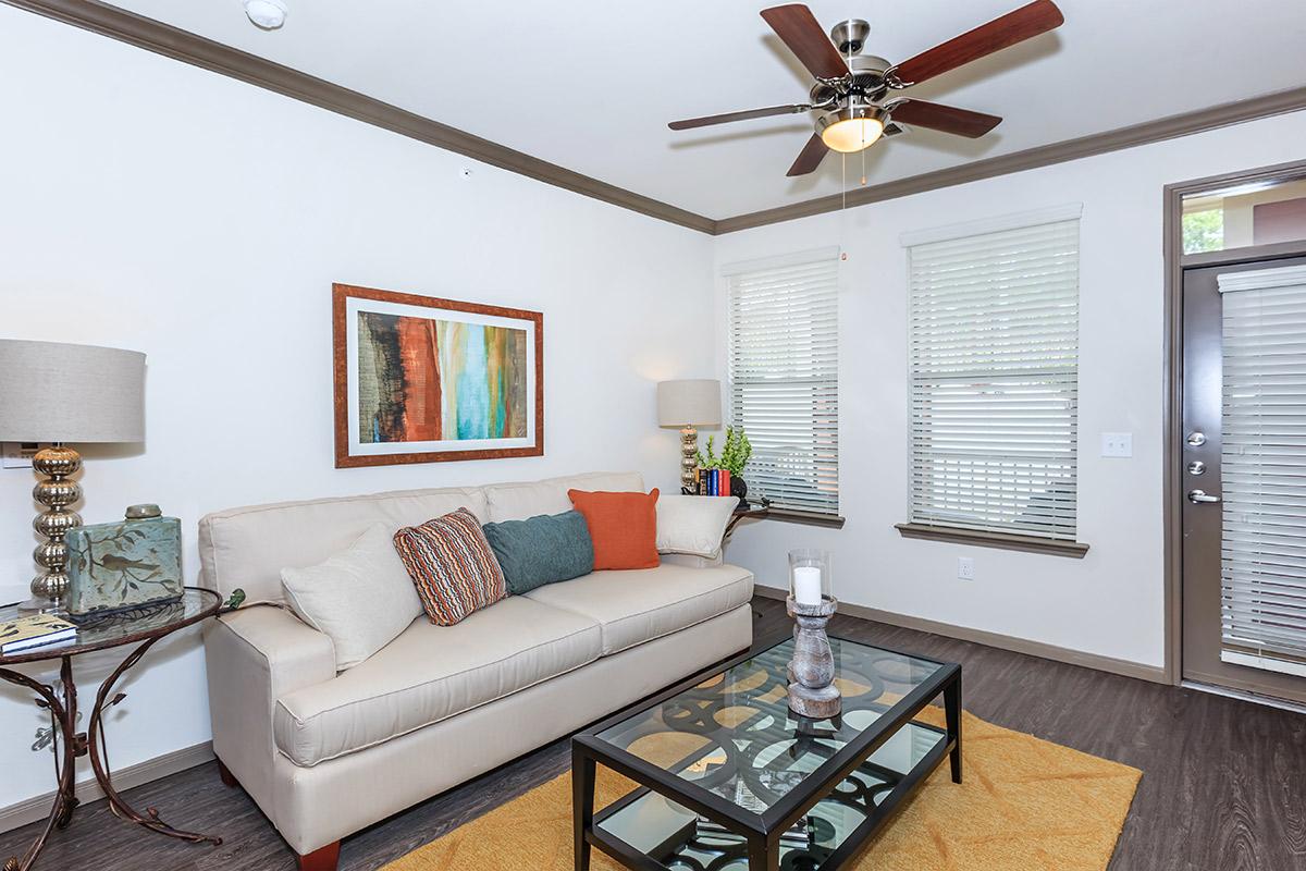 a living room filled with furniture and a flat screen tv