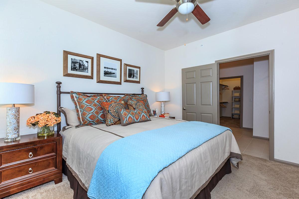 a bedroom with a bed and desk in a hotel room