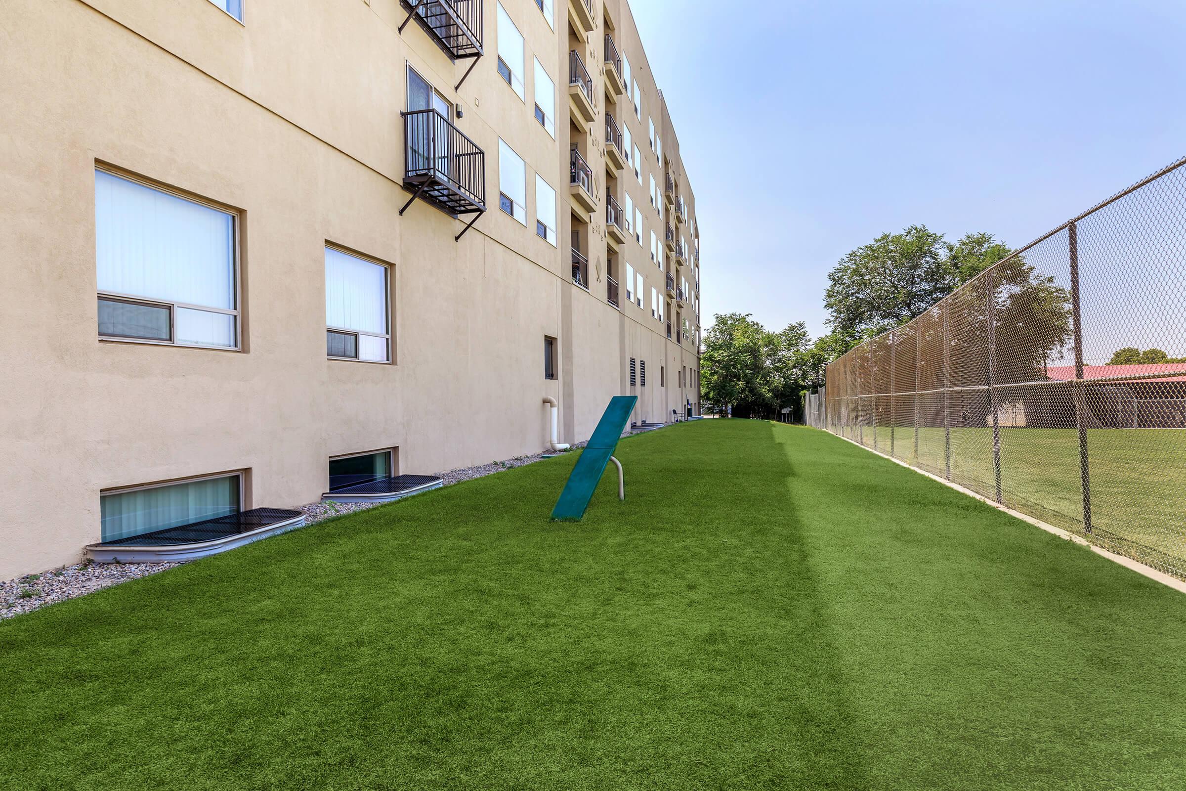 a building with a green field