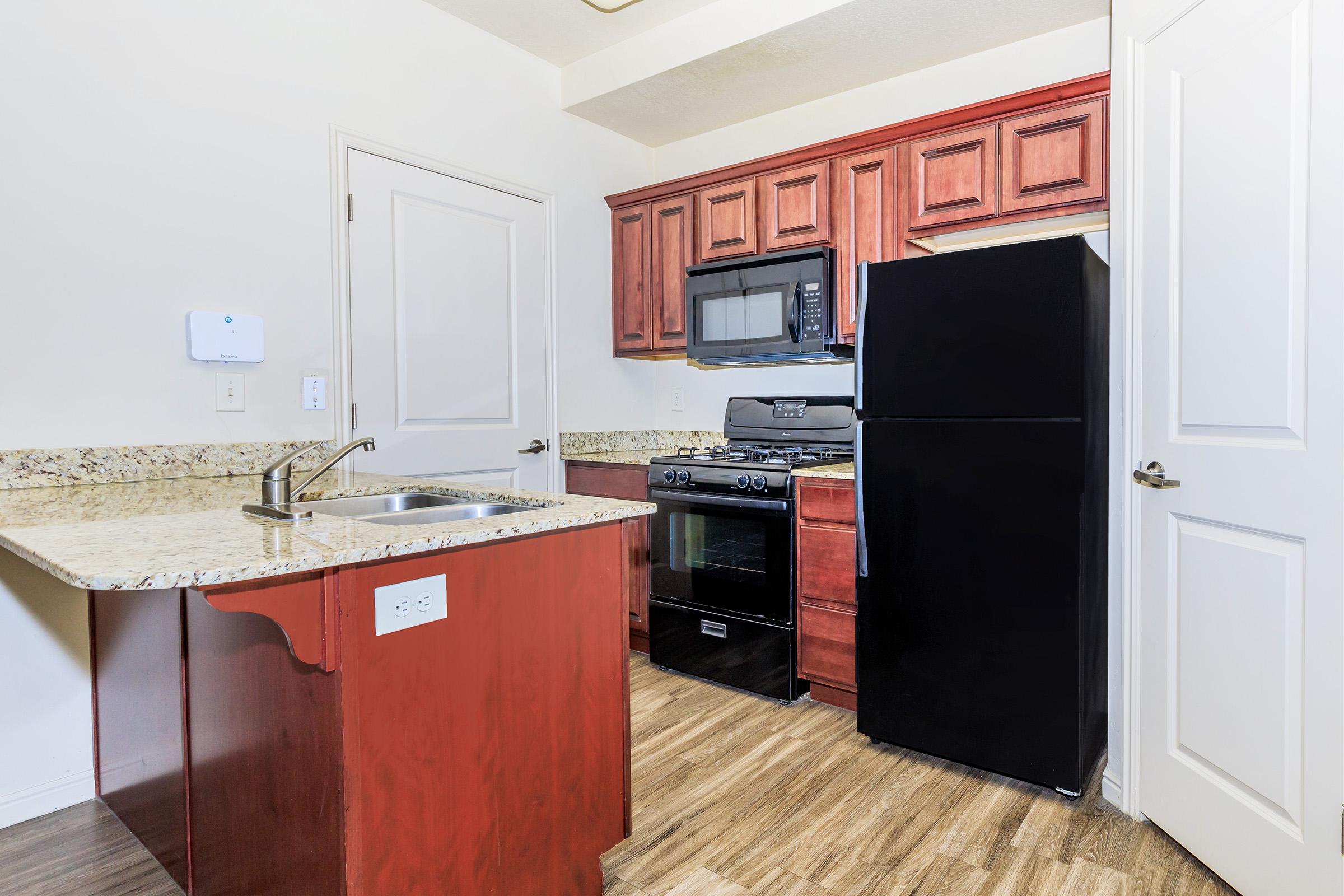 a kitchen with a sink and a microwave