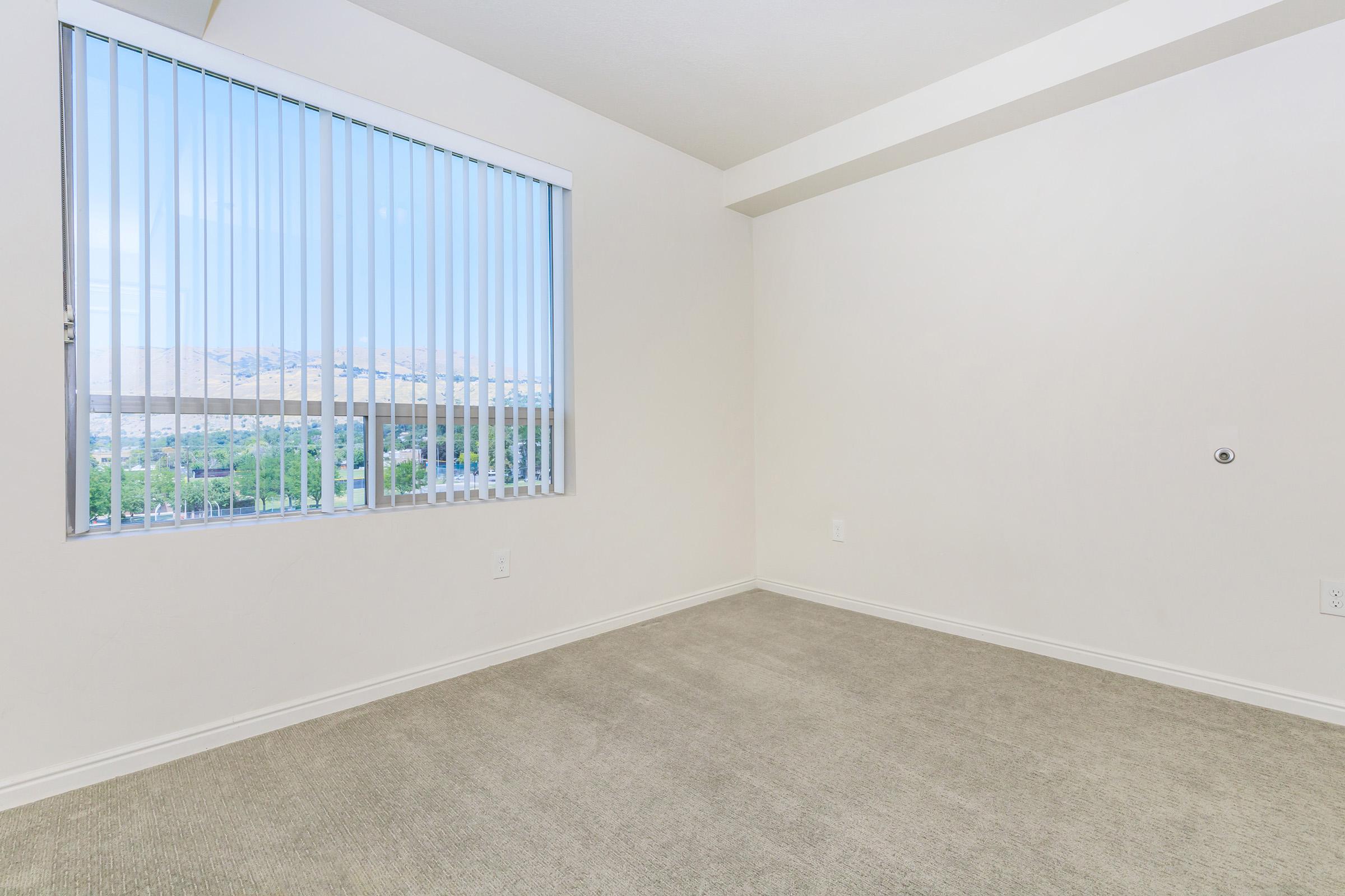 a bedroom with a large window