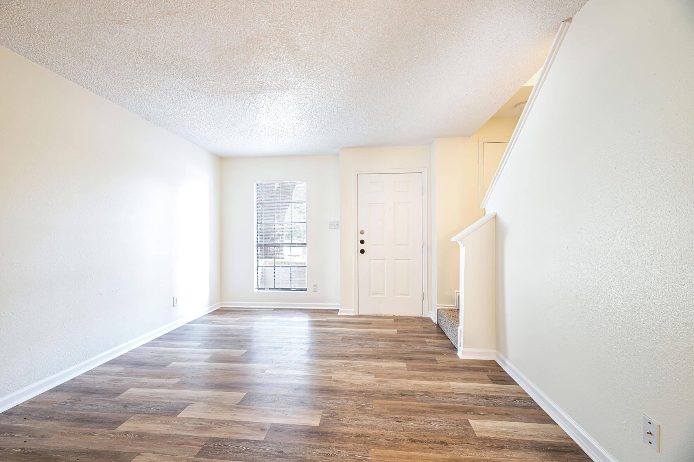 a large empty room with a wooden floor