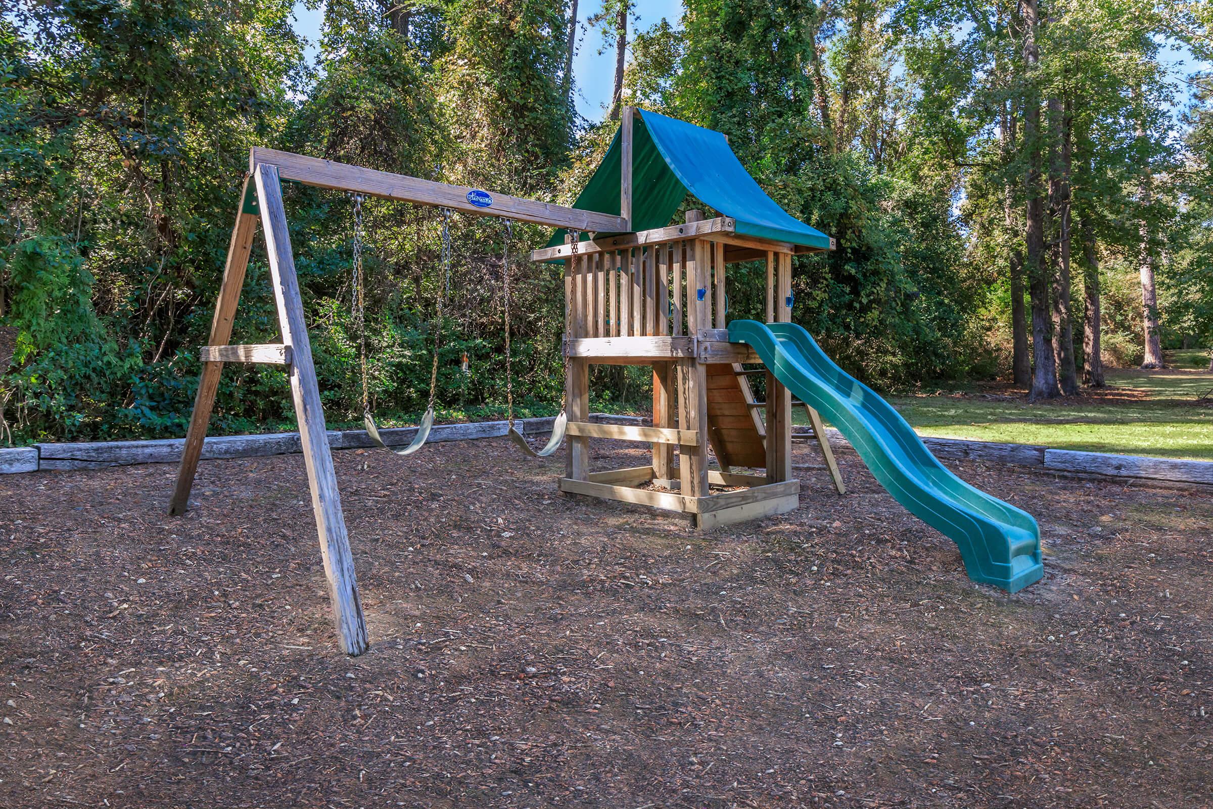 a playground in front of a picnic table