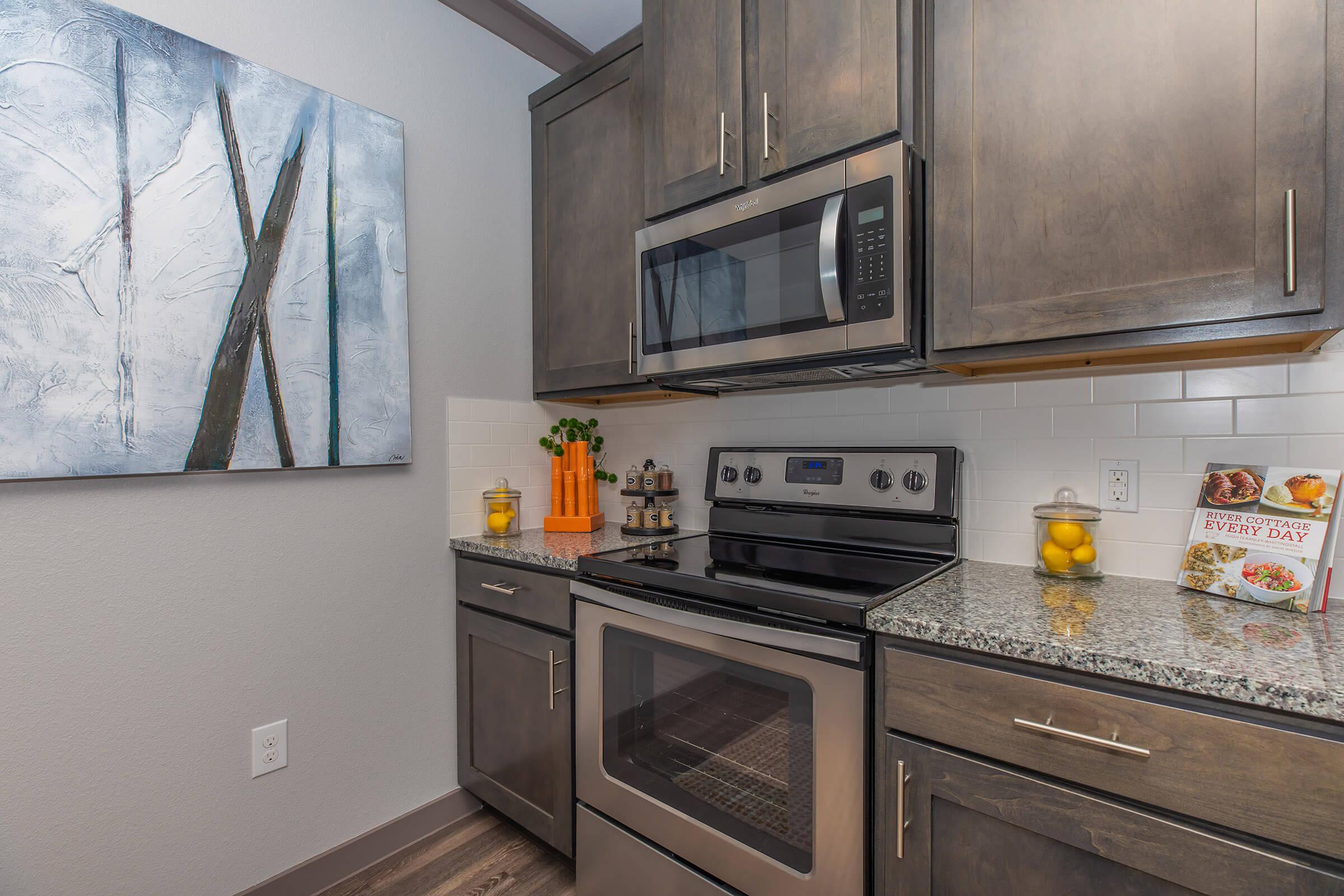 a stove top oven sitting inside of a kitchen