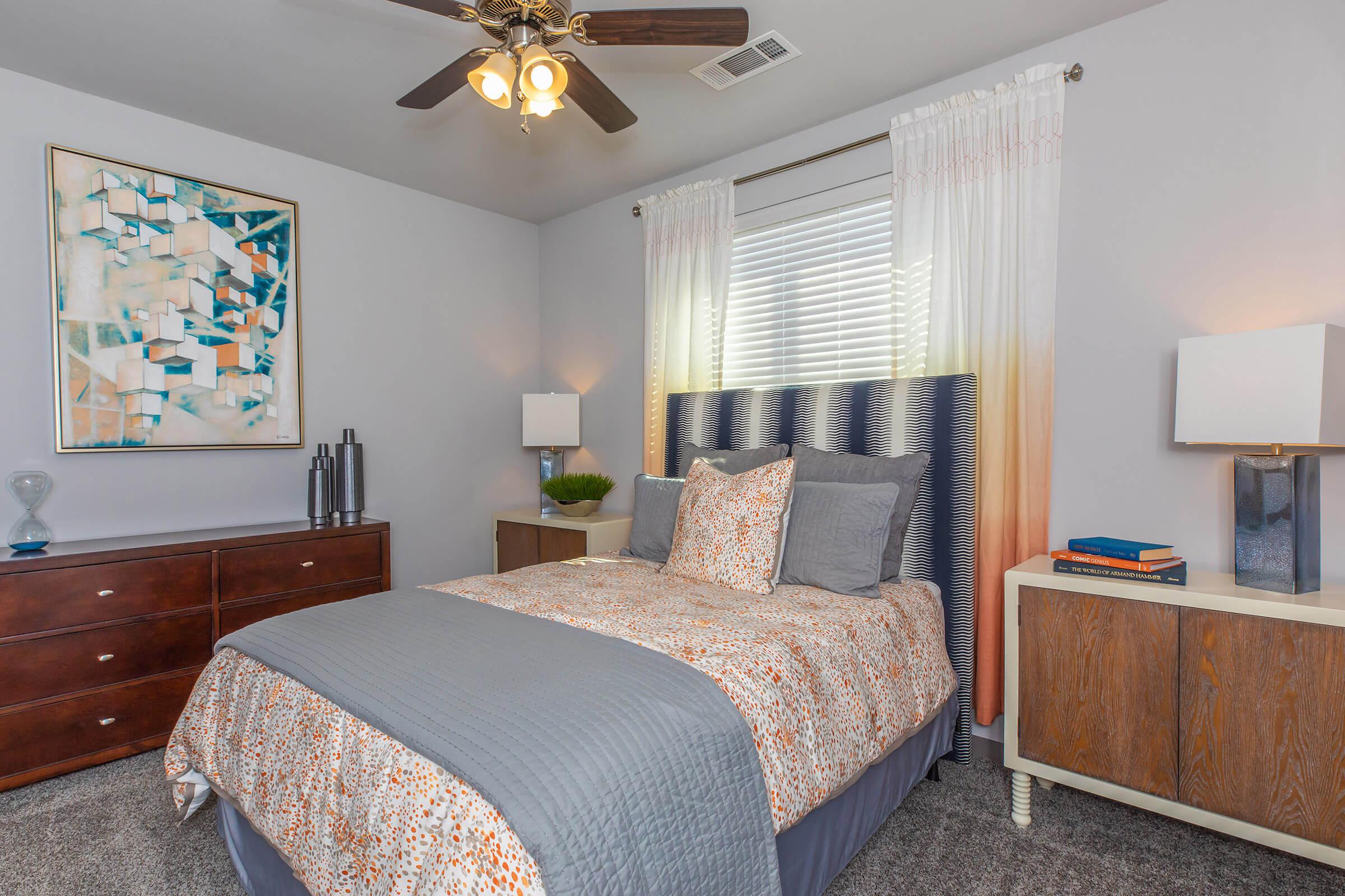 a bedroom with a bed and desk in a room