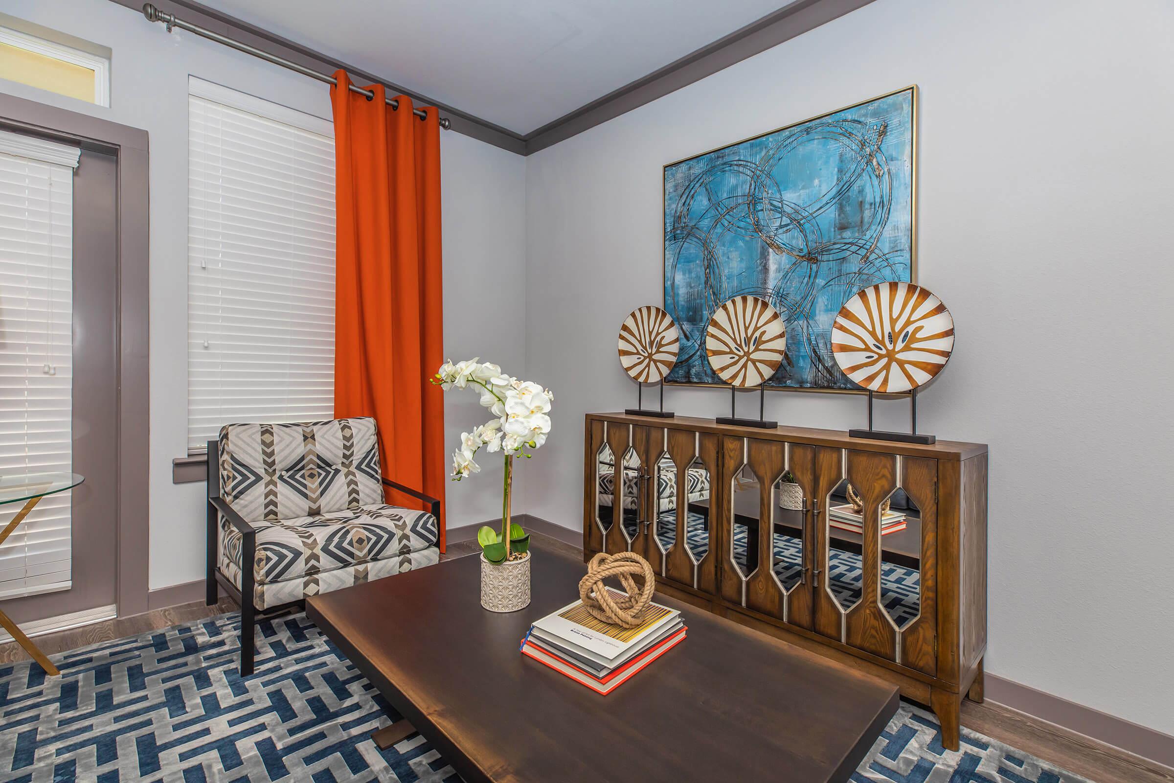 a living room filled with furniture and a large window