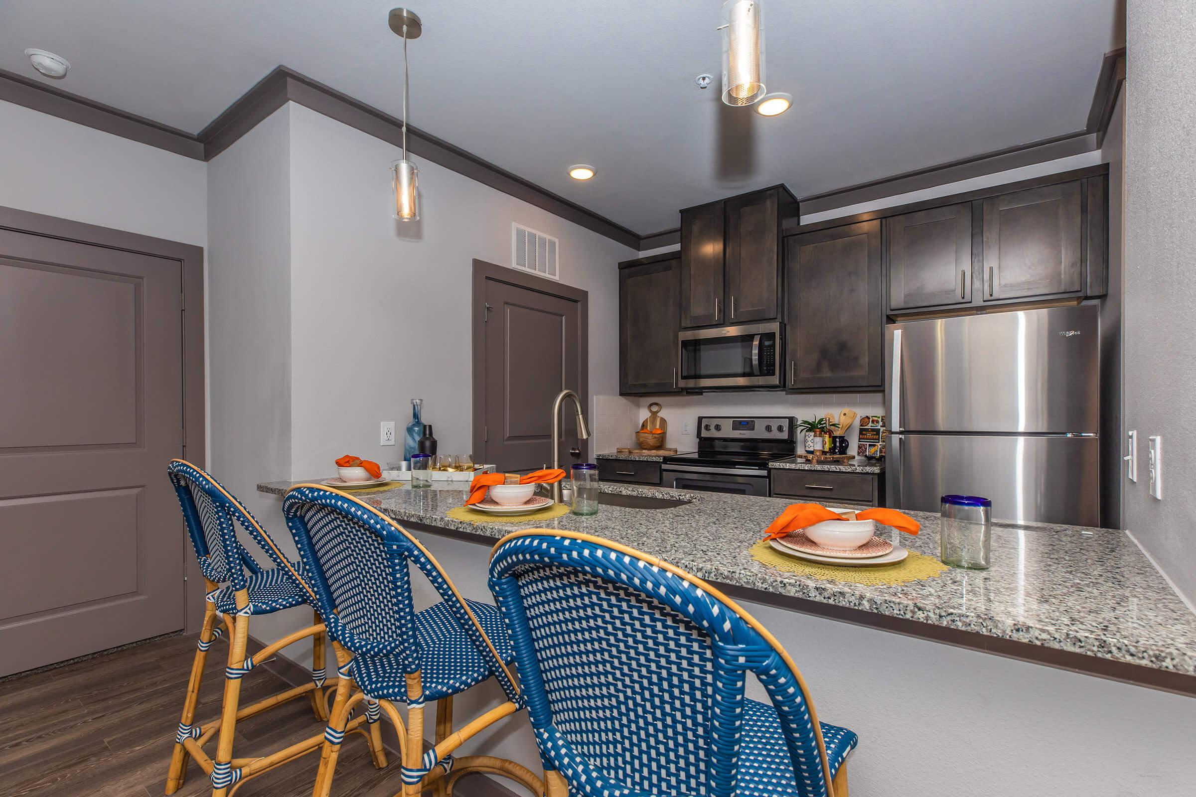 a kitchen with a blue chair