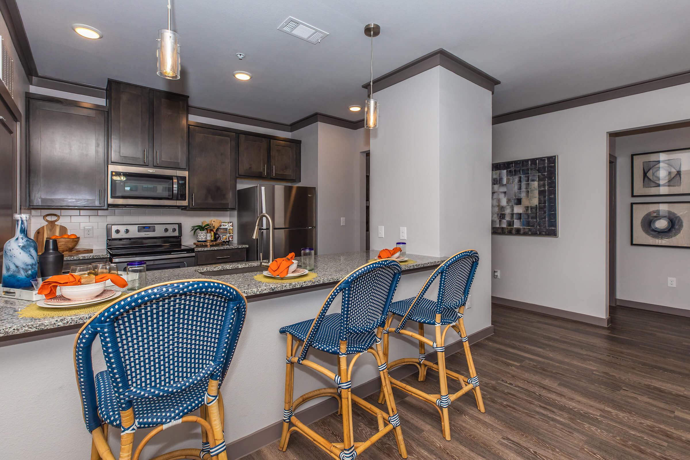 a kitchen with a blue chair