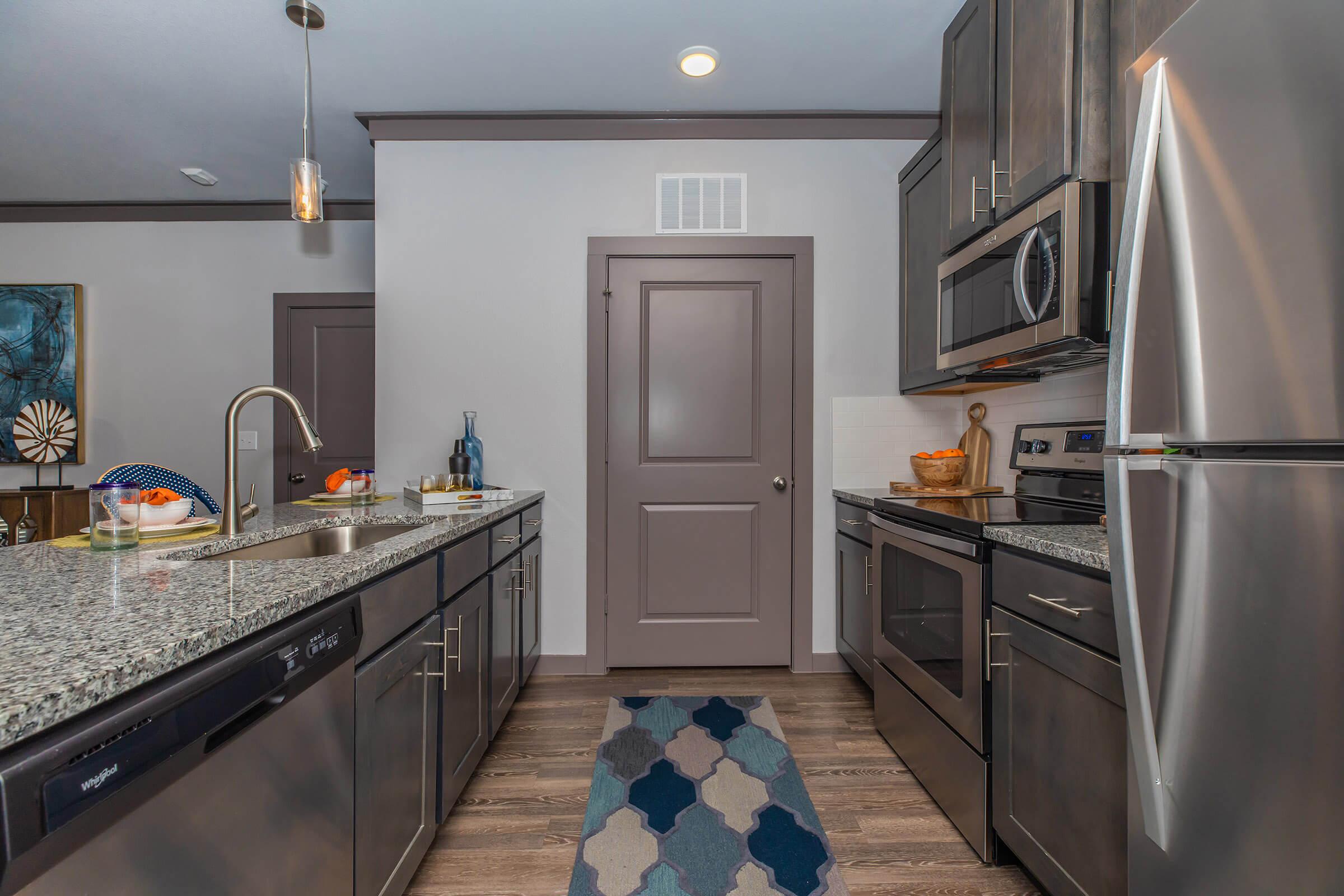 a large kitchen with stainless steel appliances