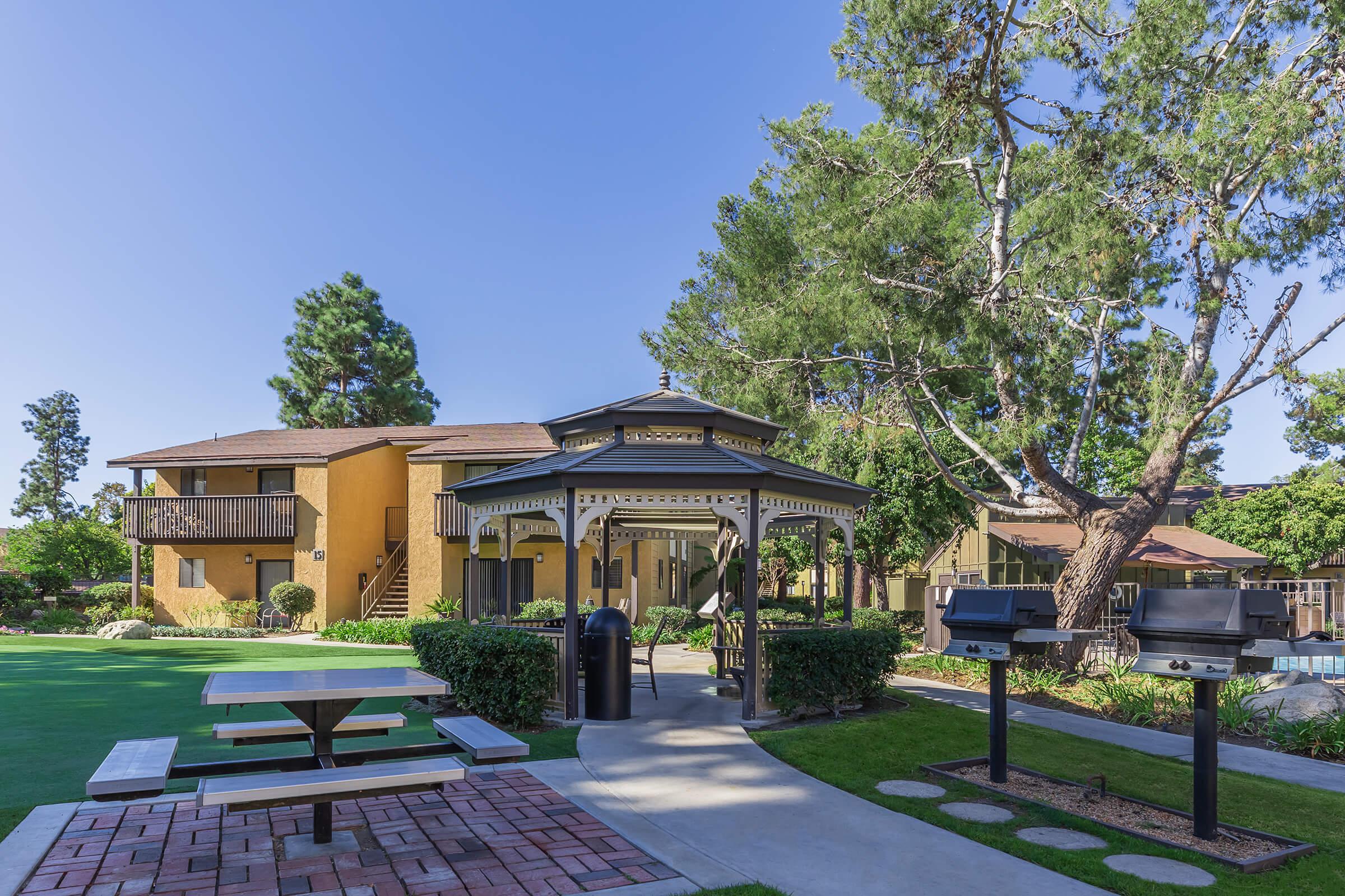 Picnic table and barbecues next to the community gazebo