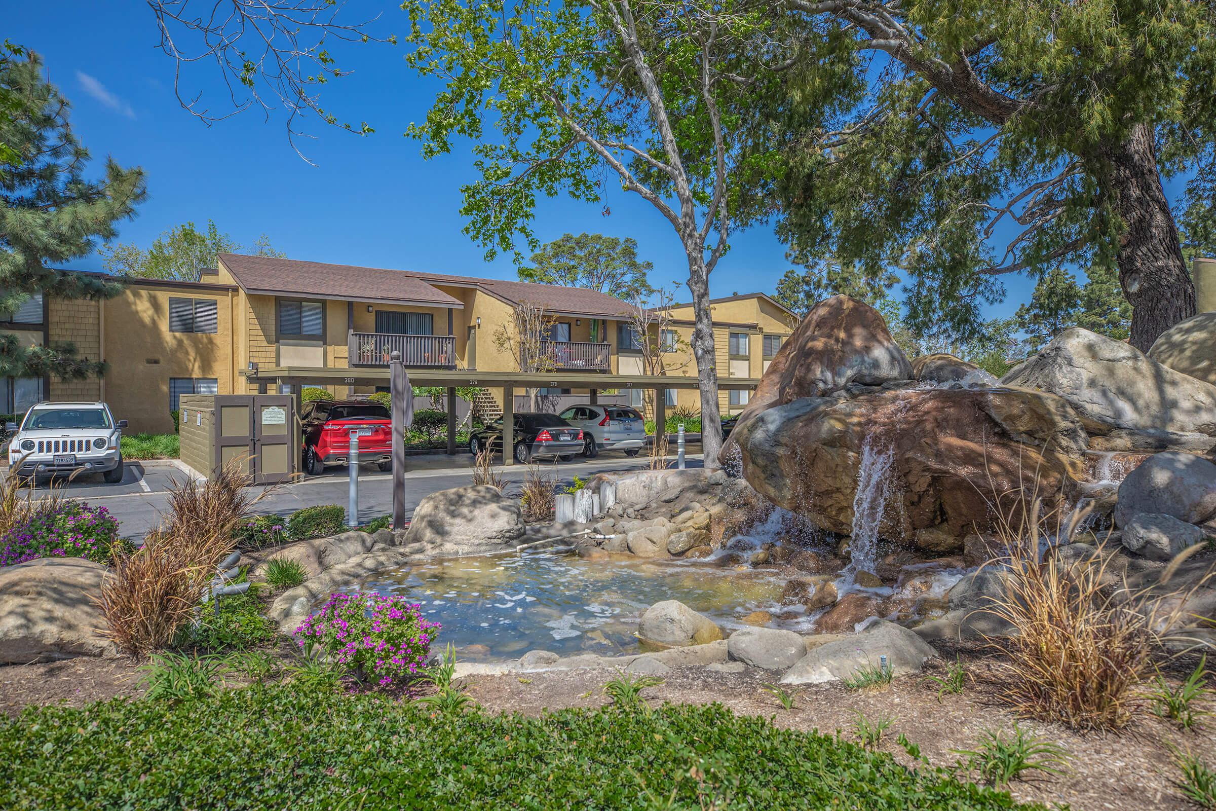 Community water feature next to covered car park