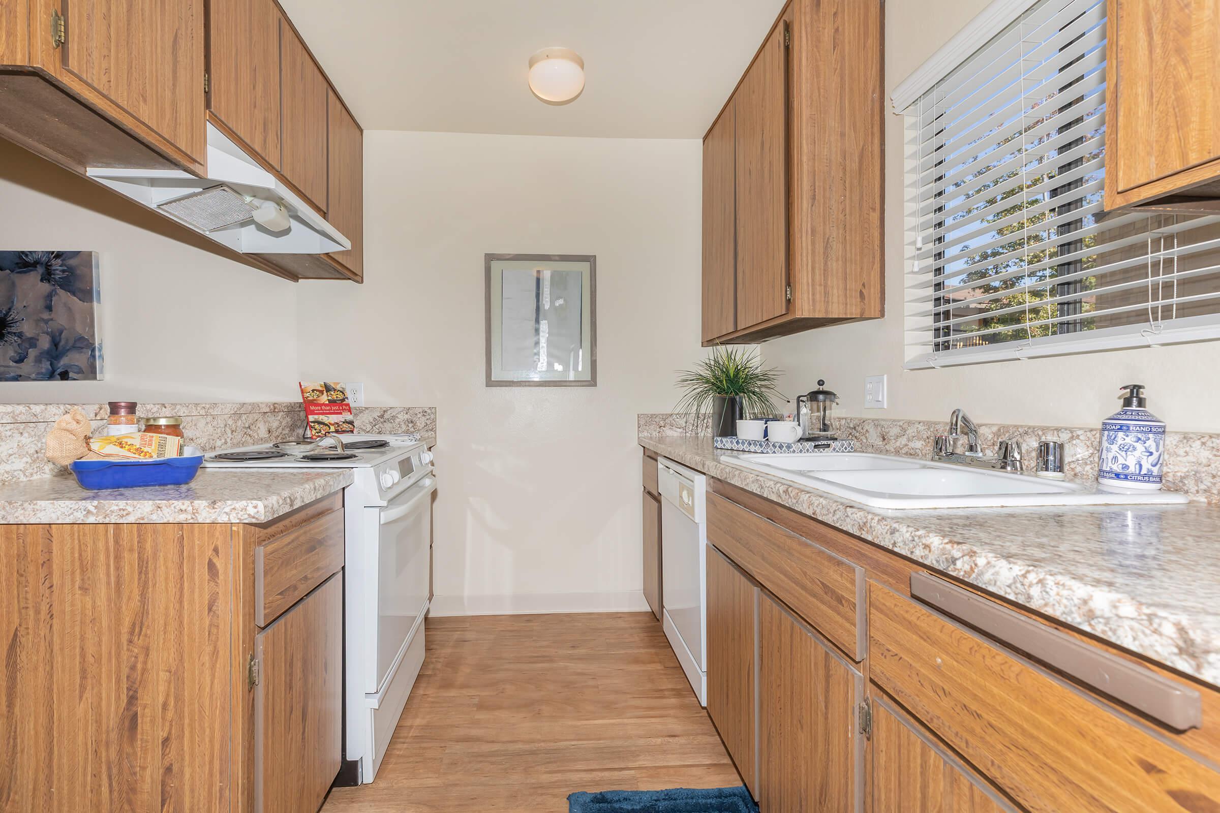 Kitchen with wooden cabinets and floors