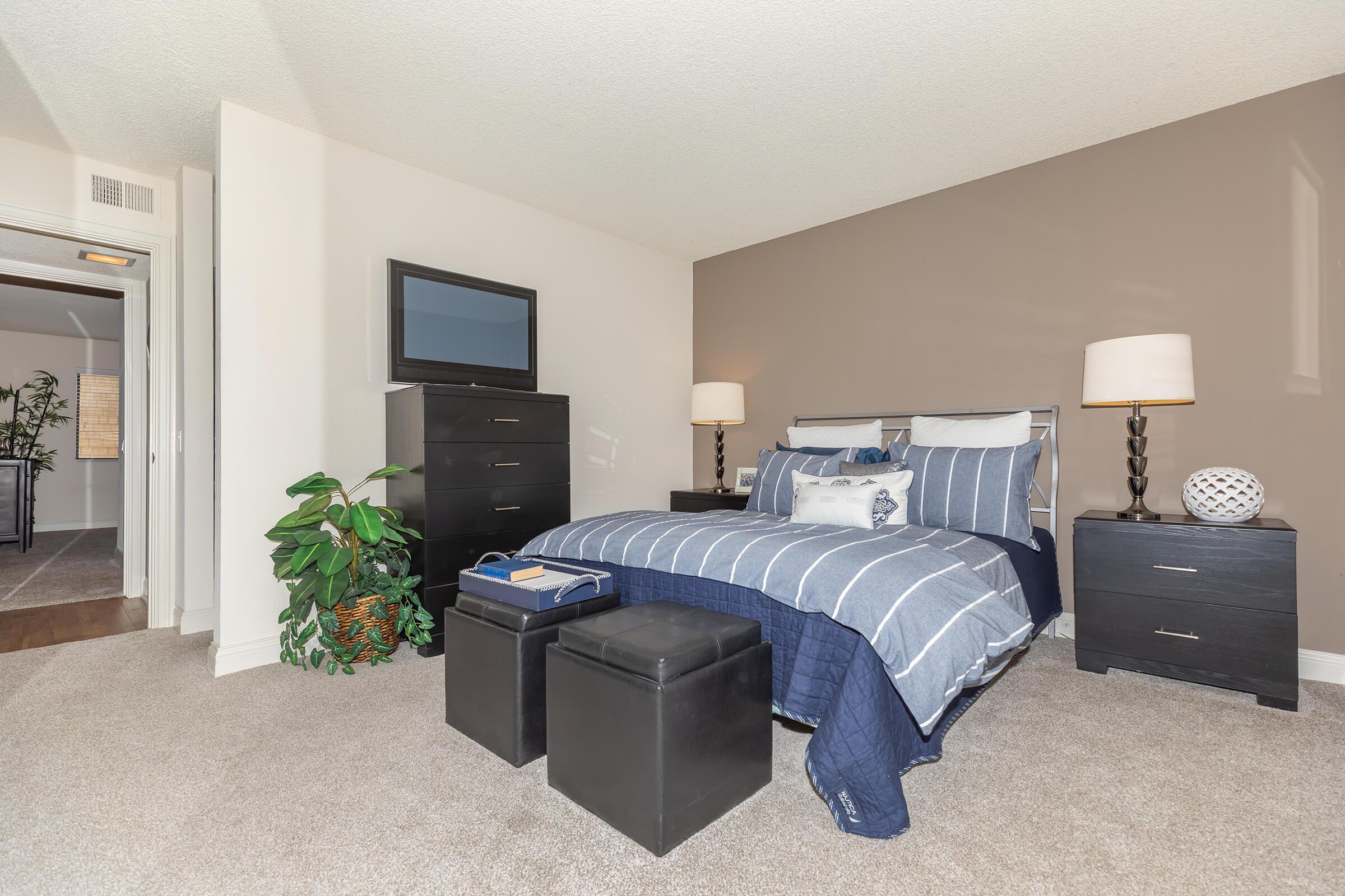 Bedroom with carpet and blue bedding