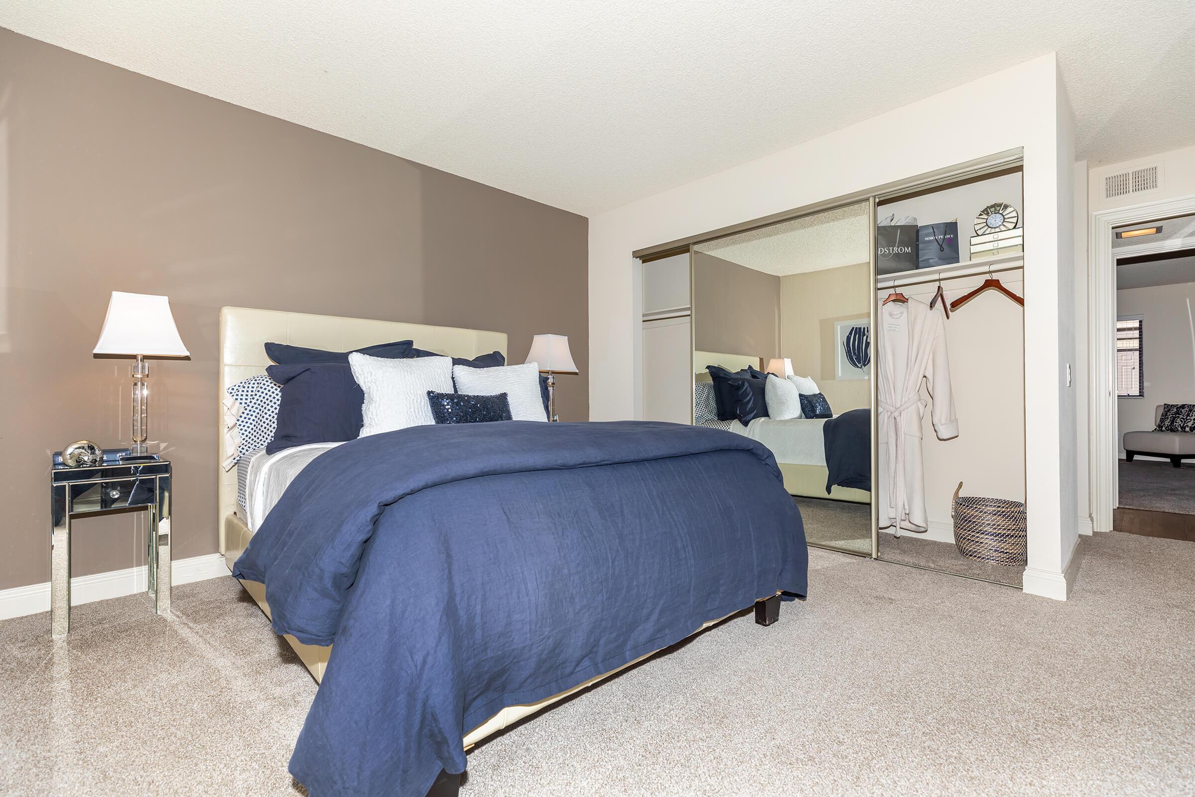 Bedroom with open sliding closet doors