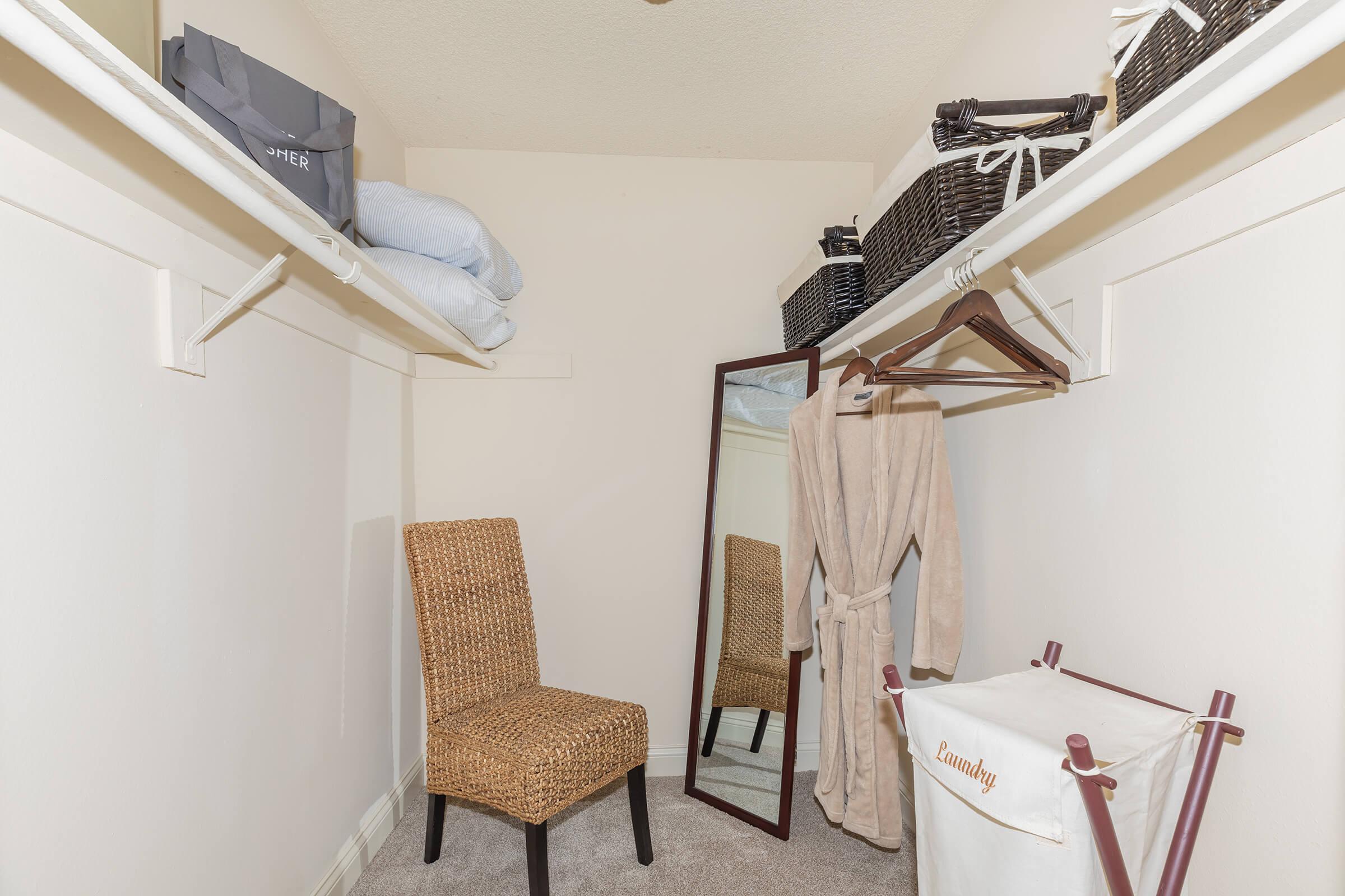 Walk-in closet with a chair