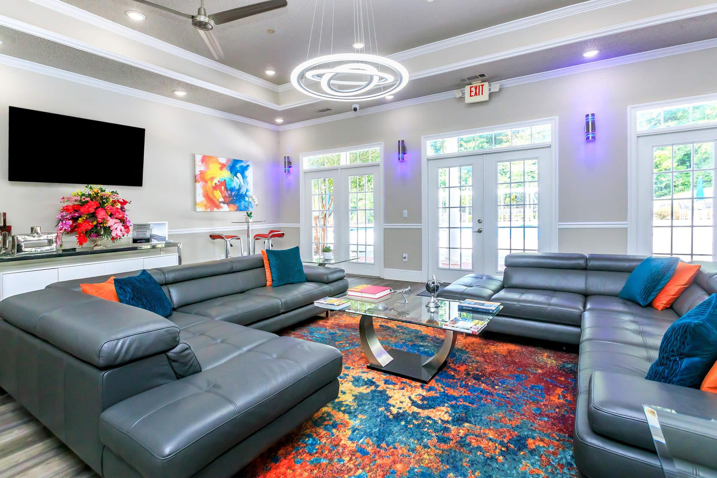 a living room filled with furniture and a flat screen tv