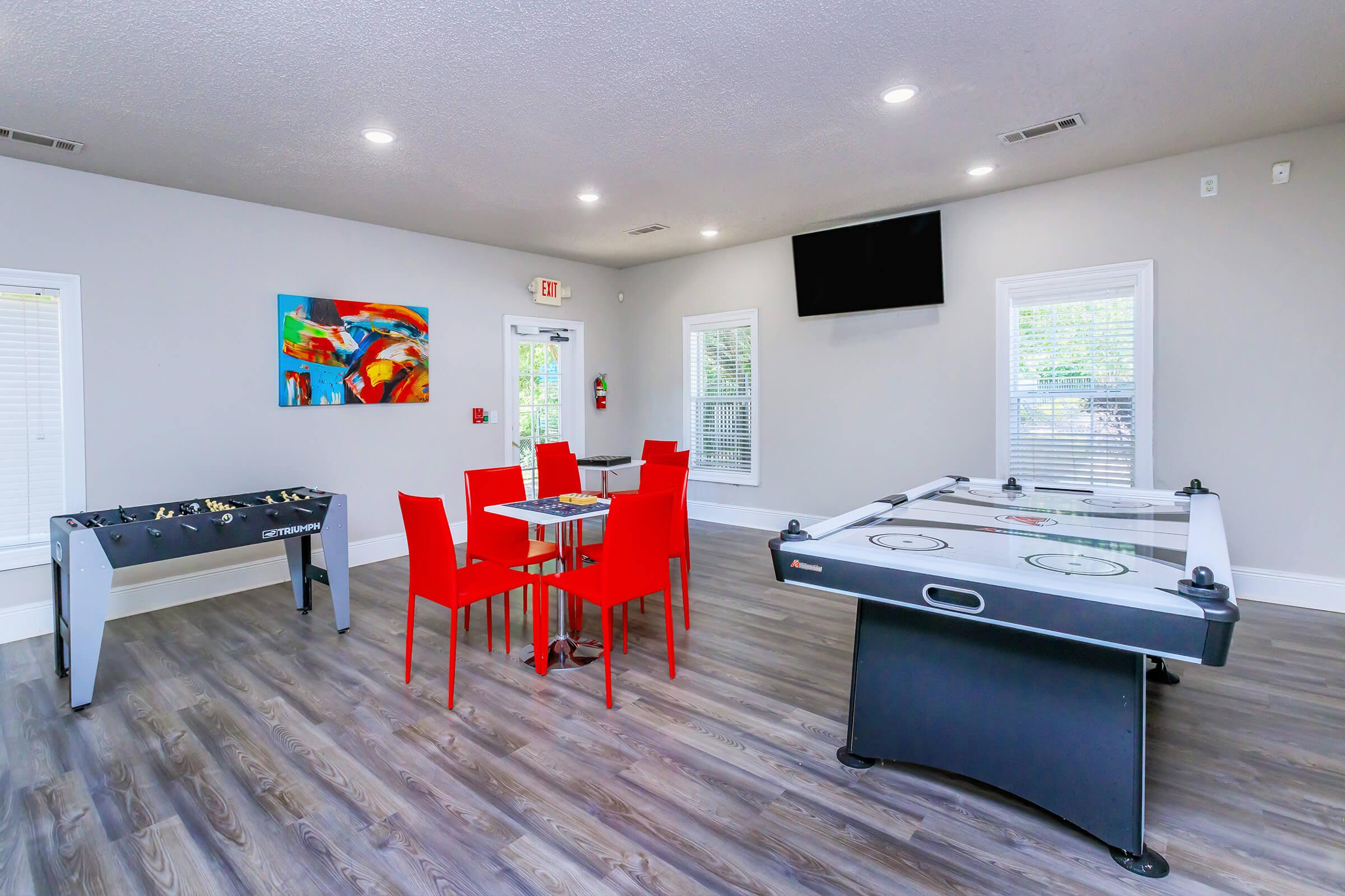 a living room filled with furniture and a flat screen tv