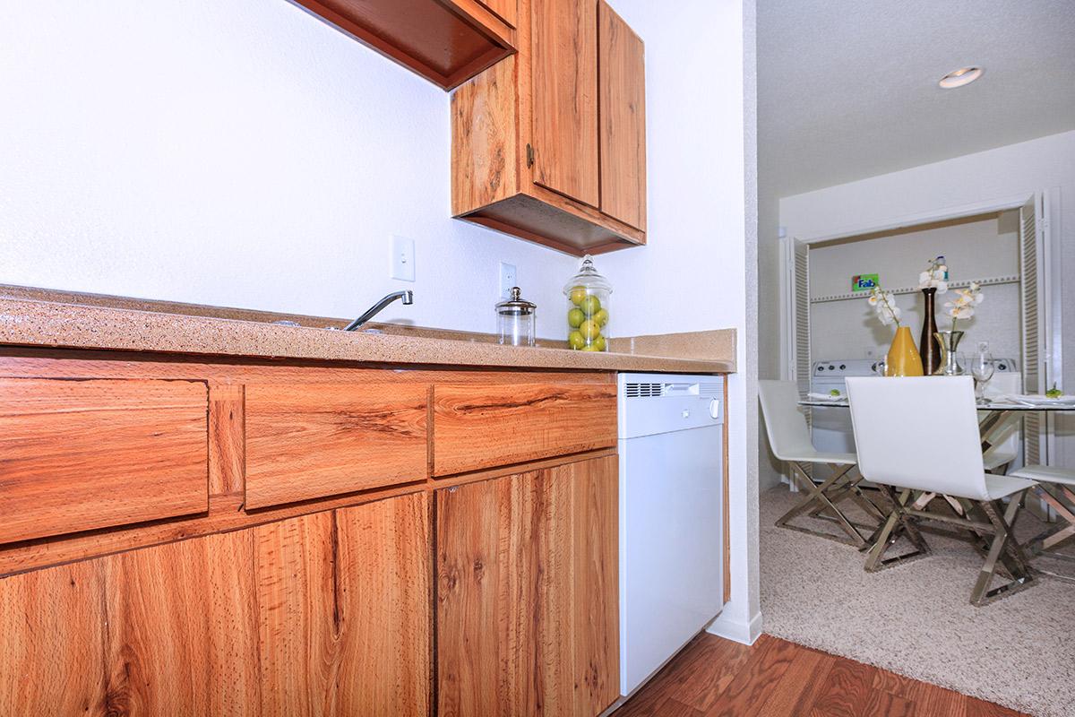 a kitchen with wooden cabinets