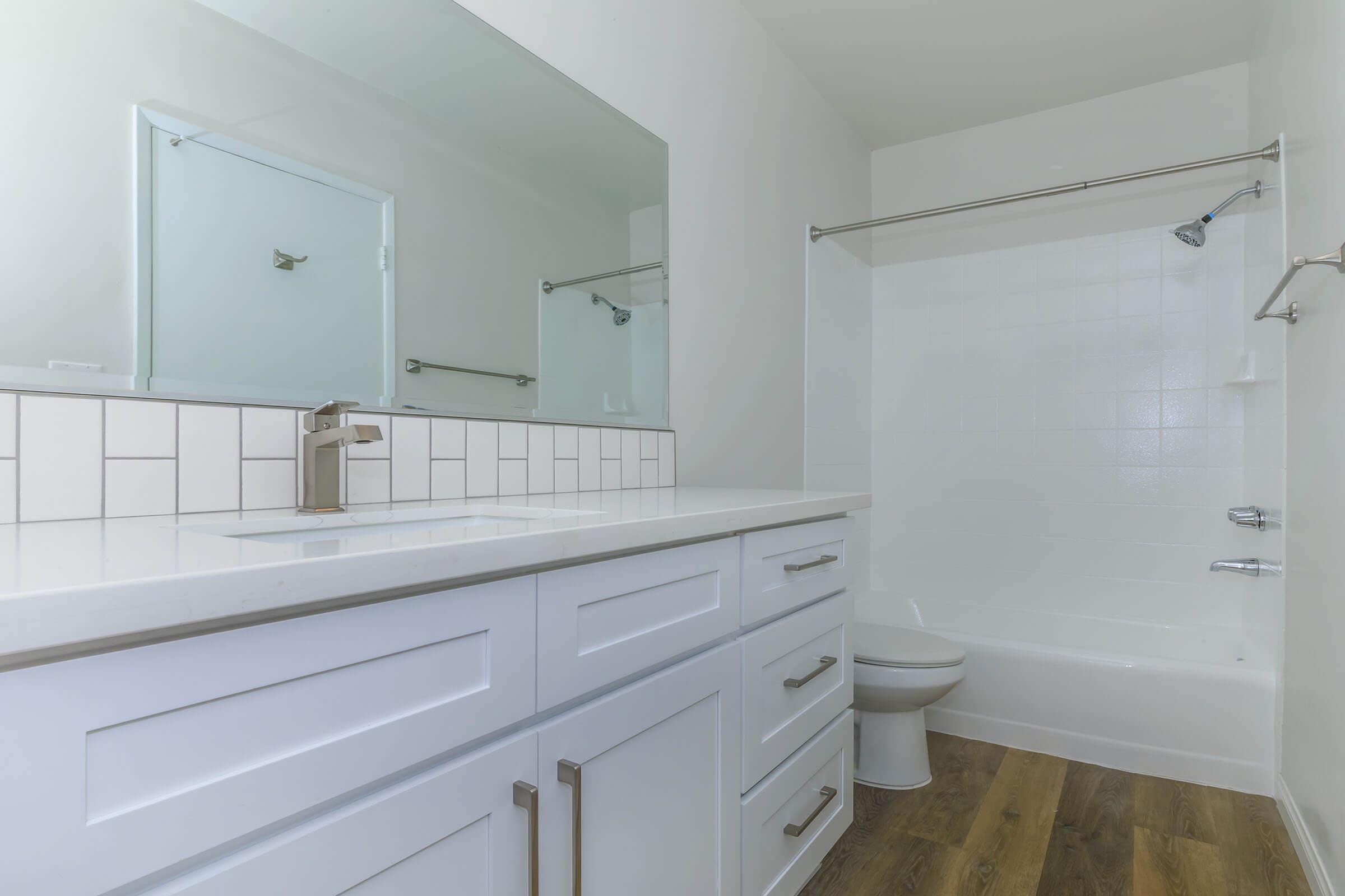 a kitchen with a sink and a mirror