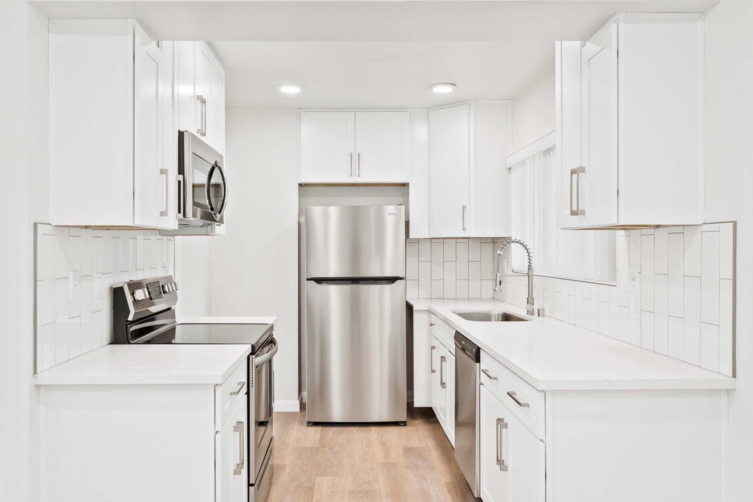 a kitchen with a stove and a refrigerator