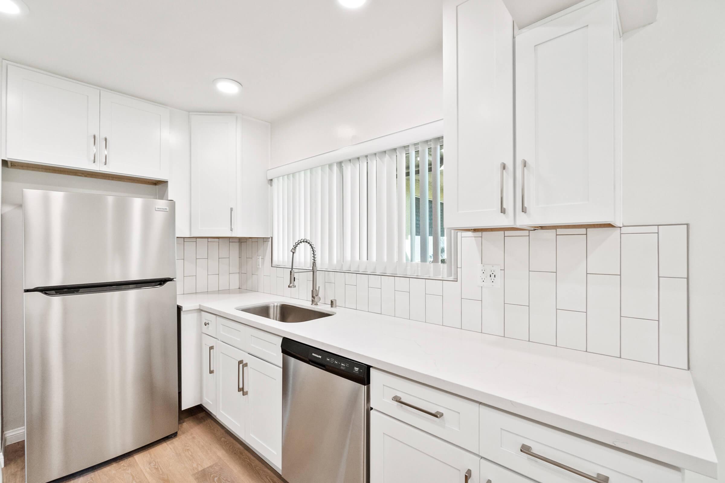 a kitchen with a stove sink and refrigerator