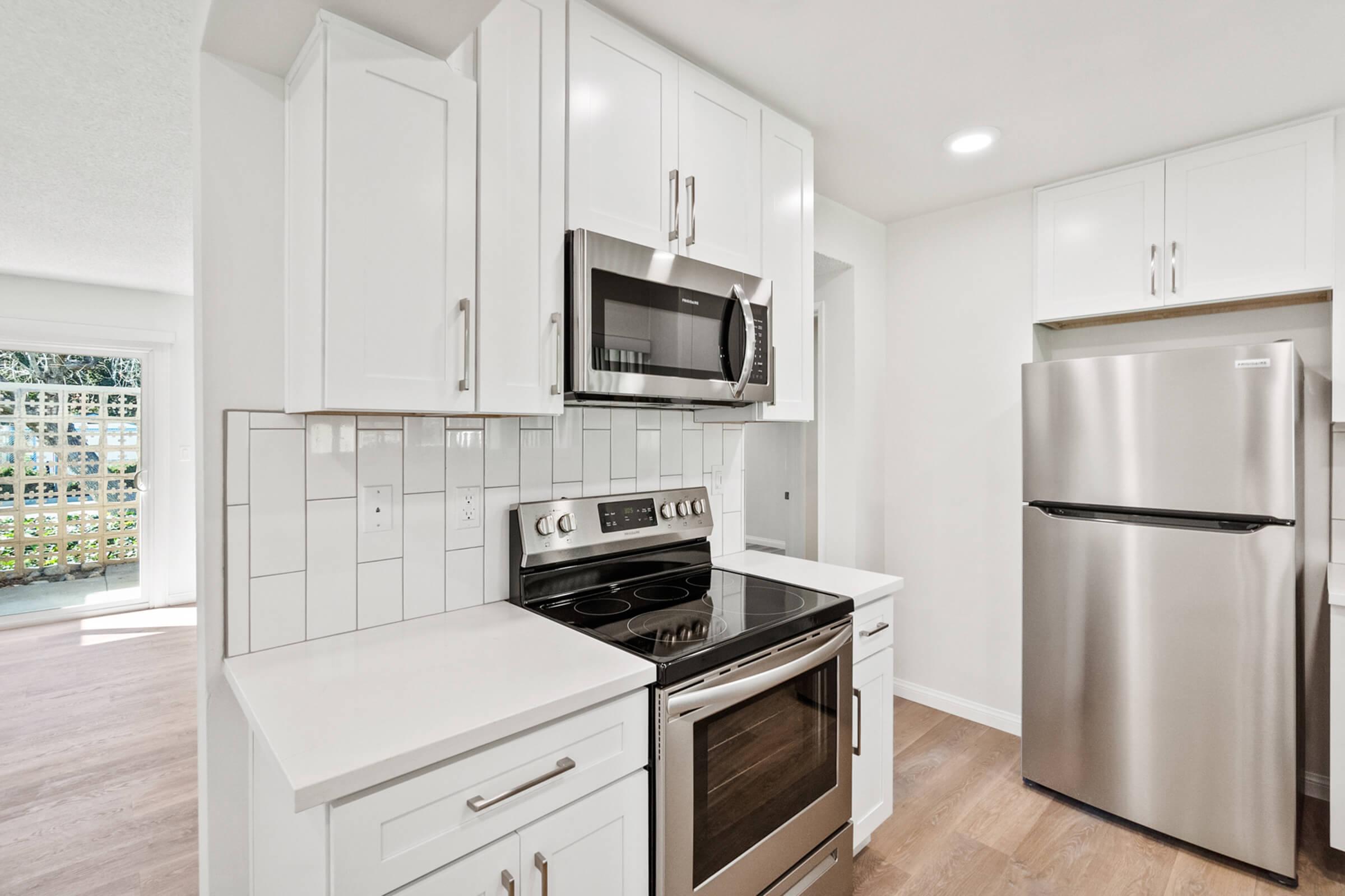 a kitchen with a stove top oven sitting inside of a refrigerator