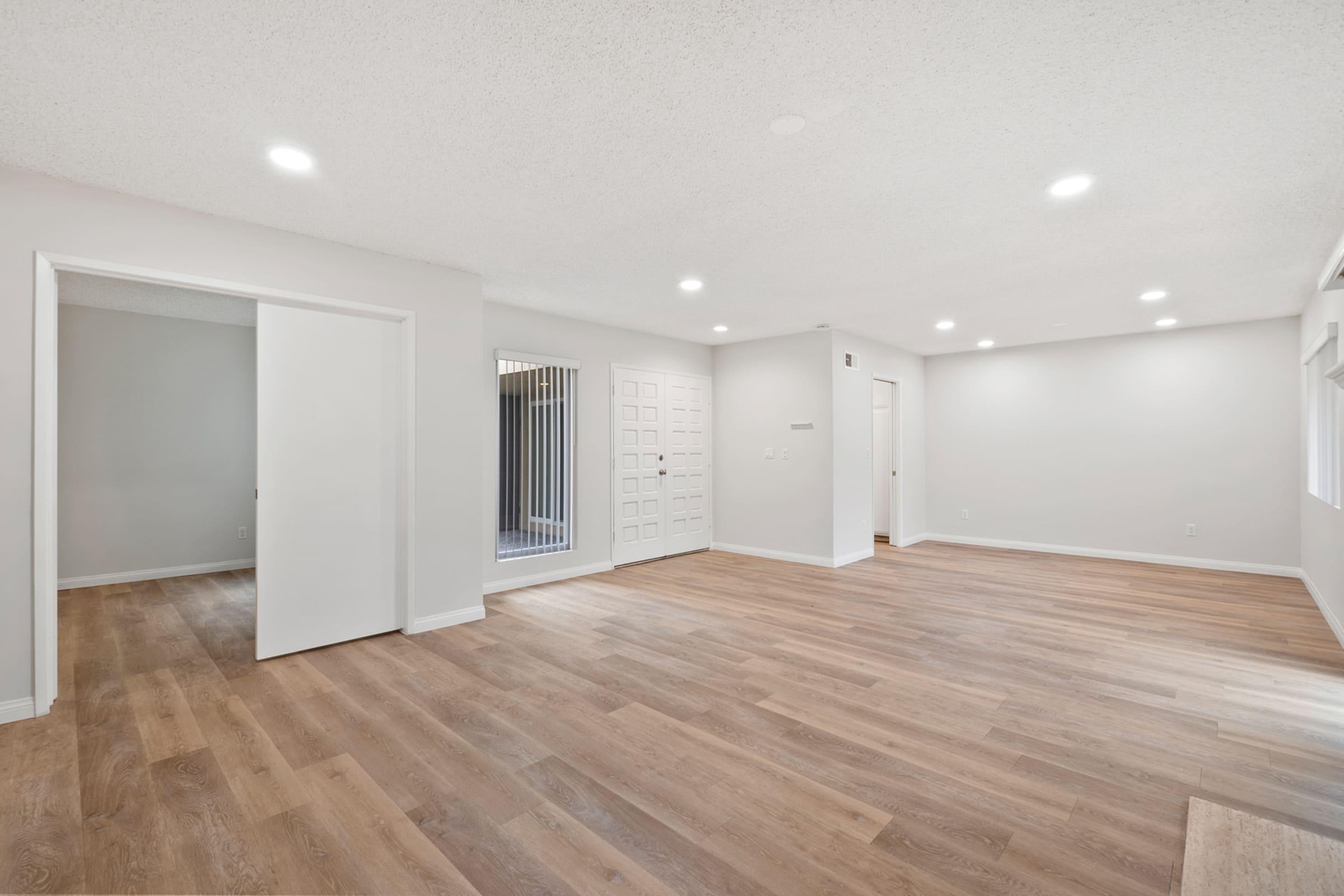 a large empty room with a wood floor