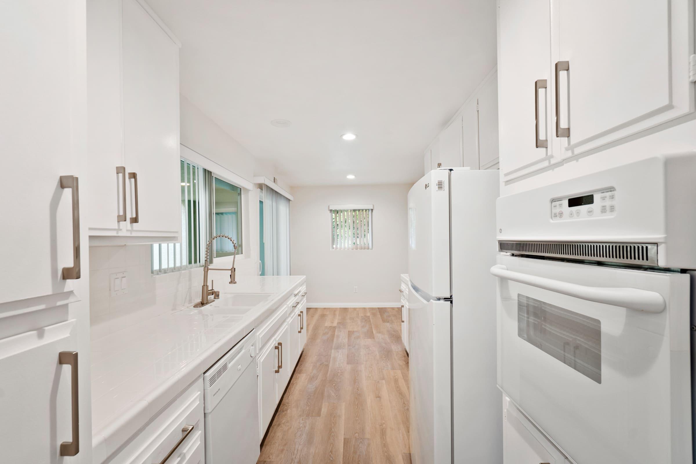 a kitchen with a sink and a refrigerator