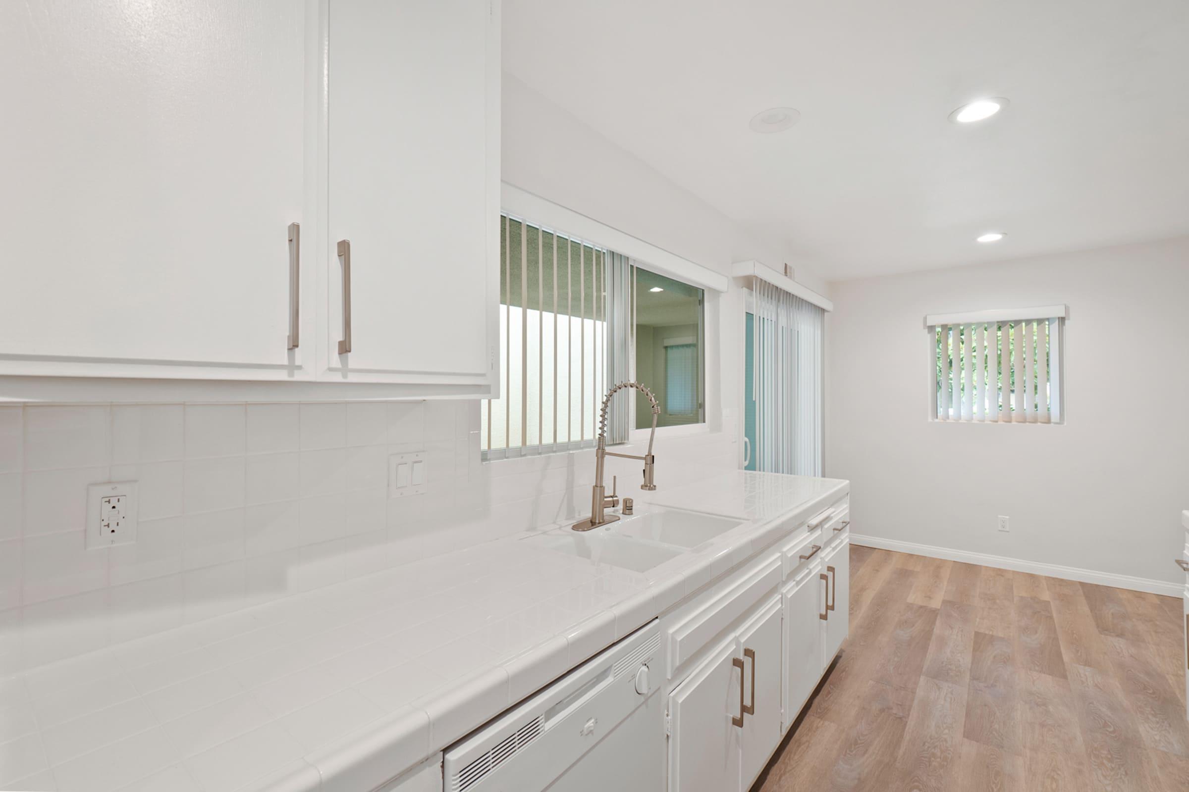 a kitchen with a sink and a mirror