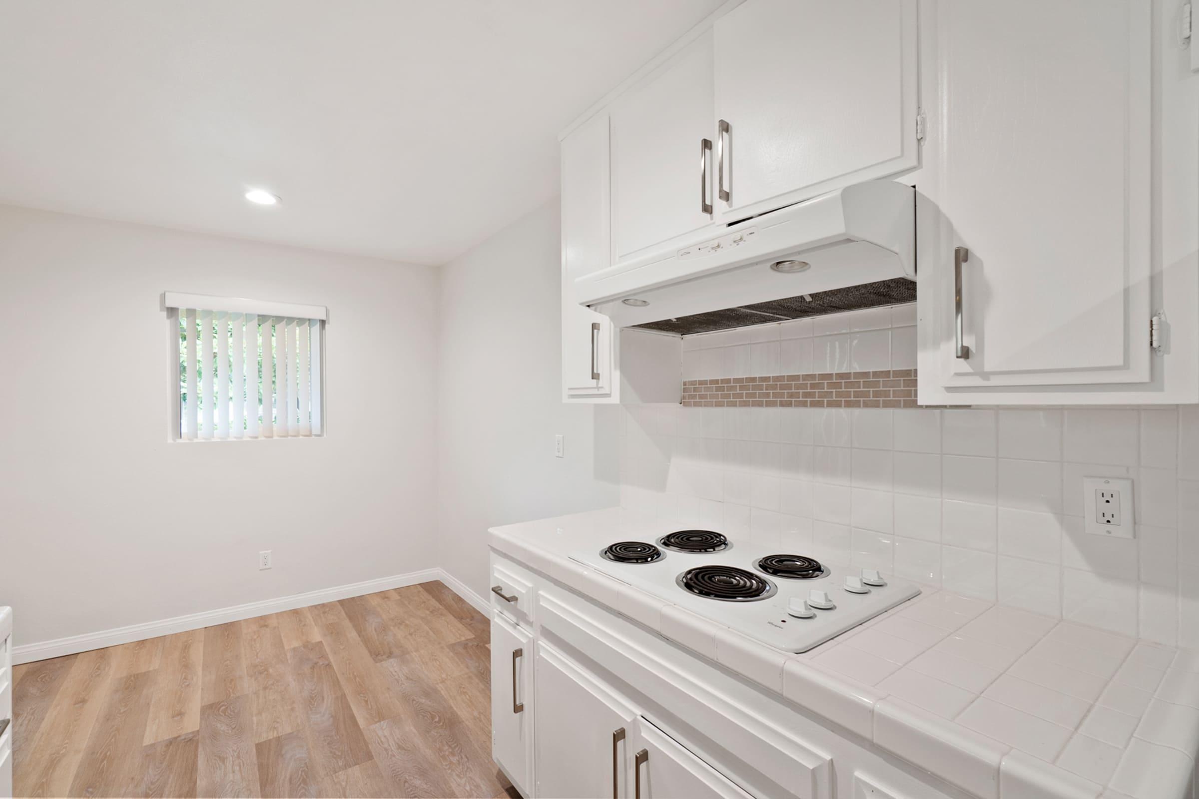 a stove top oven sitting inside of a kitchen