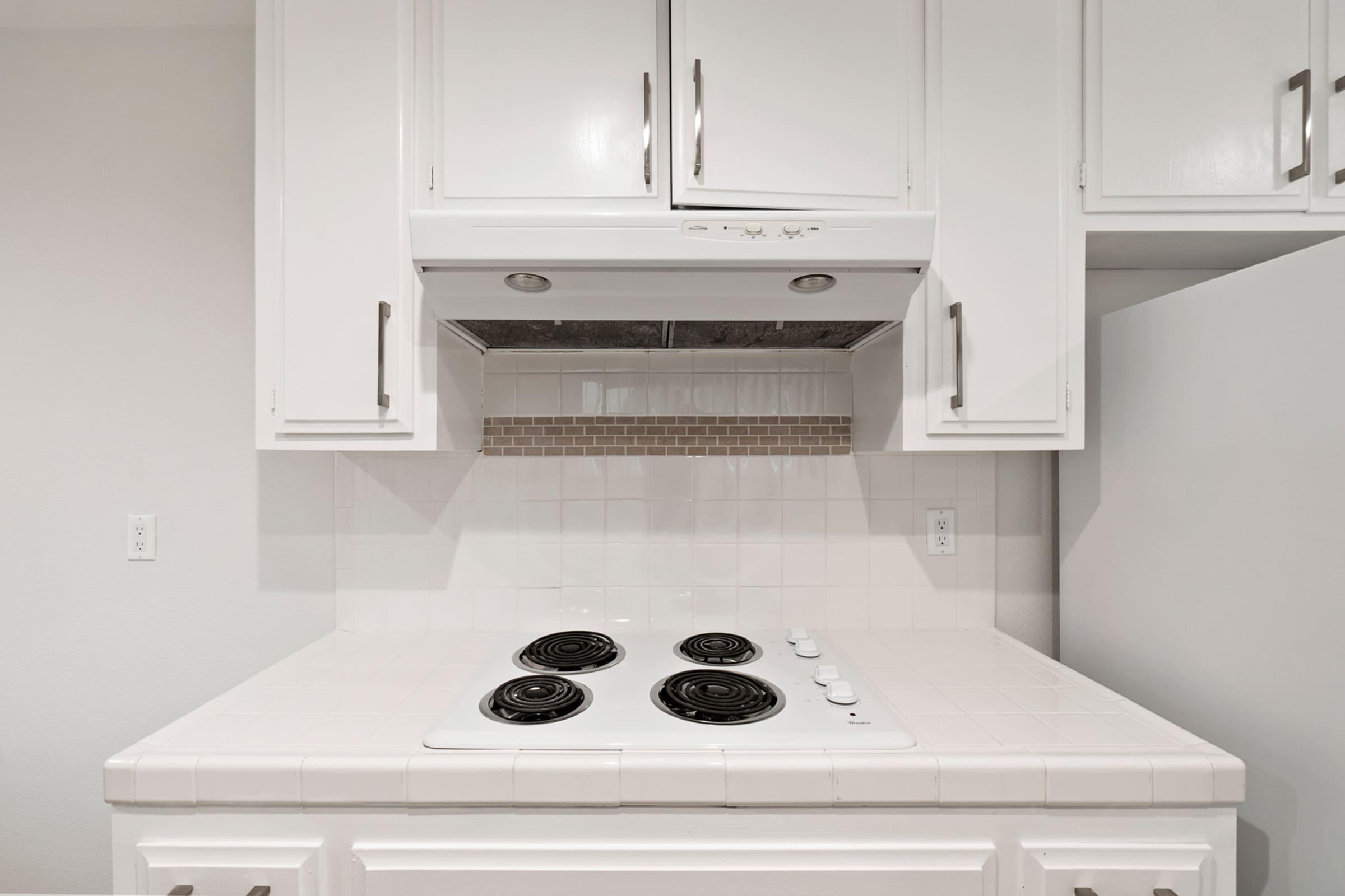 a stove top oven sitting inside of a kitchen