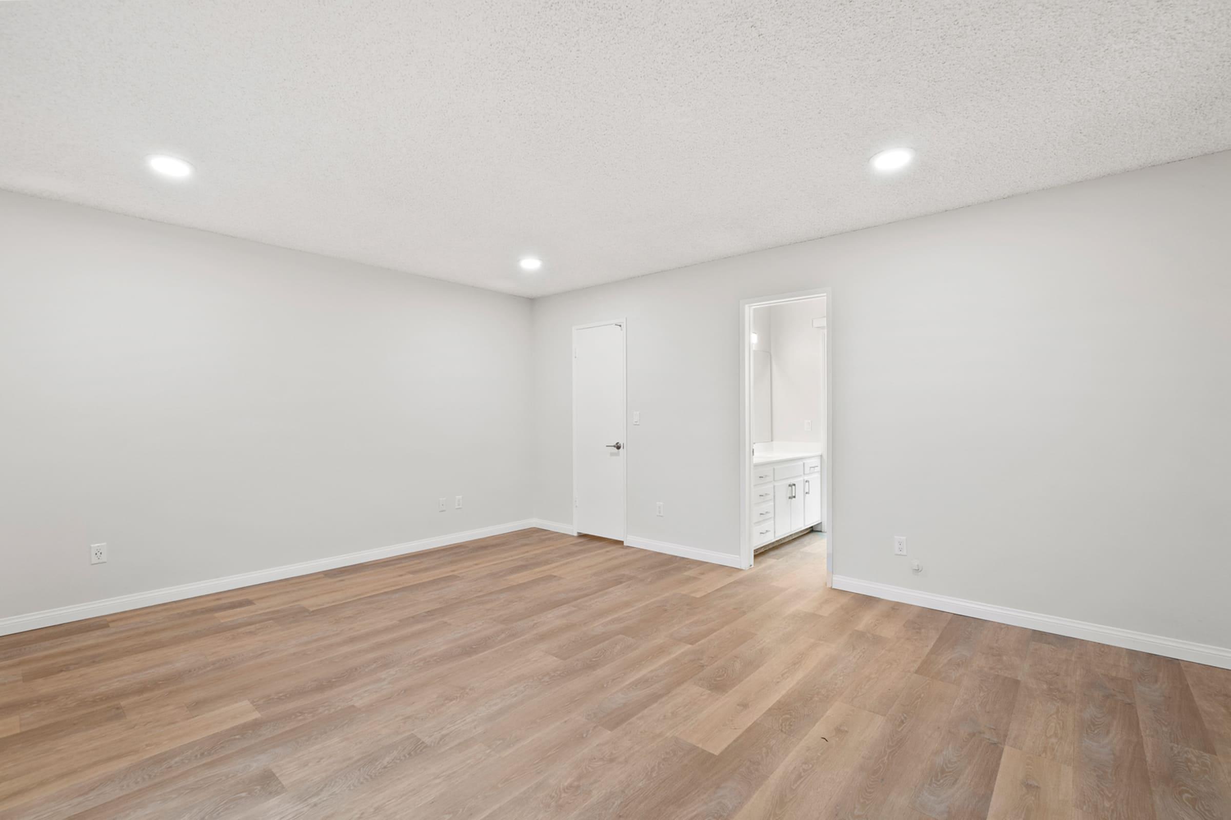 a large empty room with a wooden floor