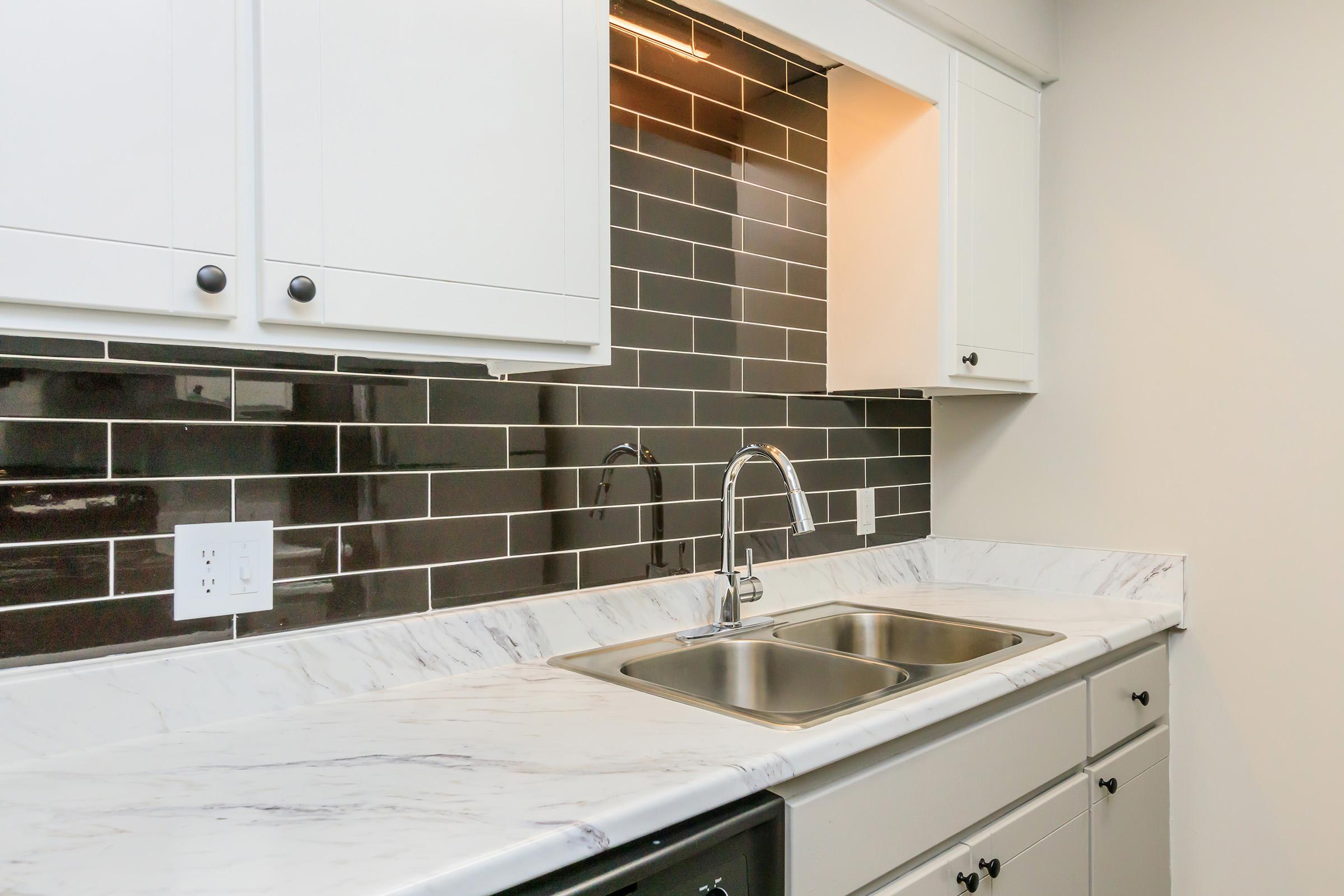 Check out the kitchens with black tile backsplashes.