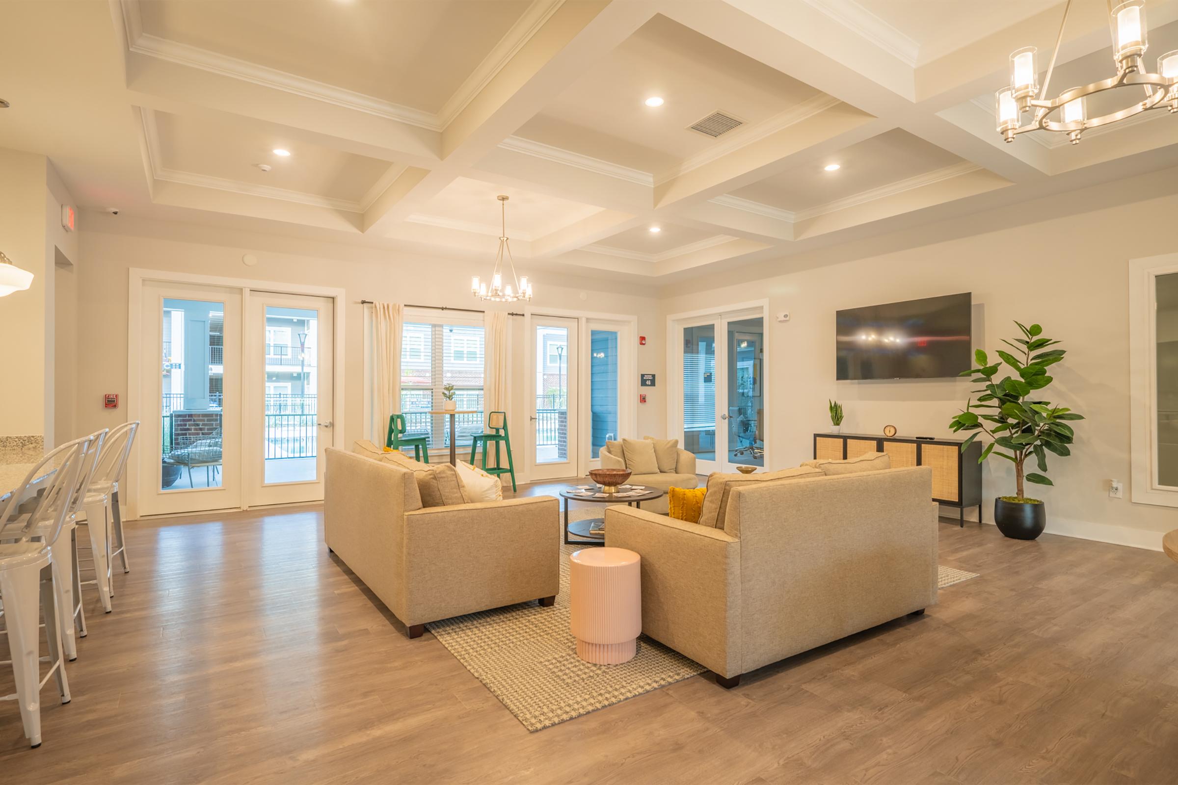 a living room filled with furniture and a large window