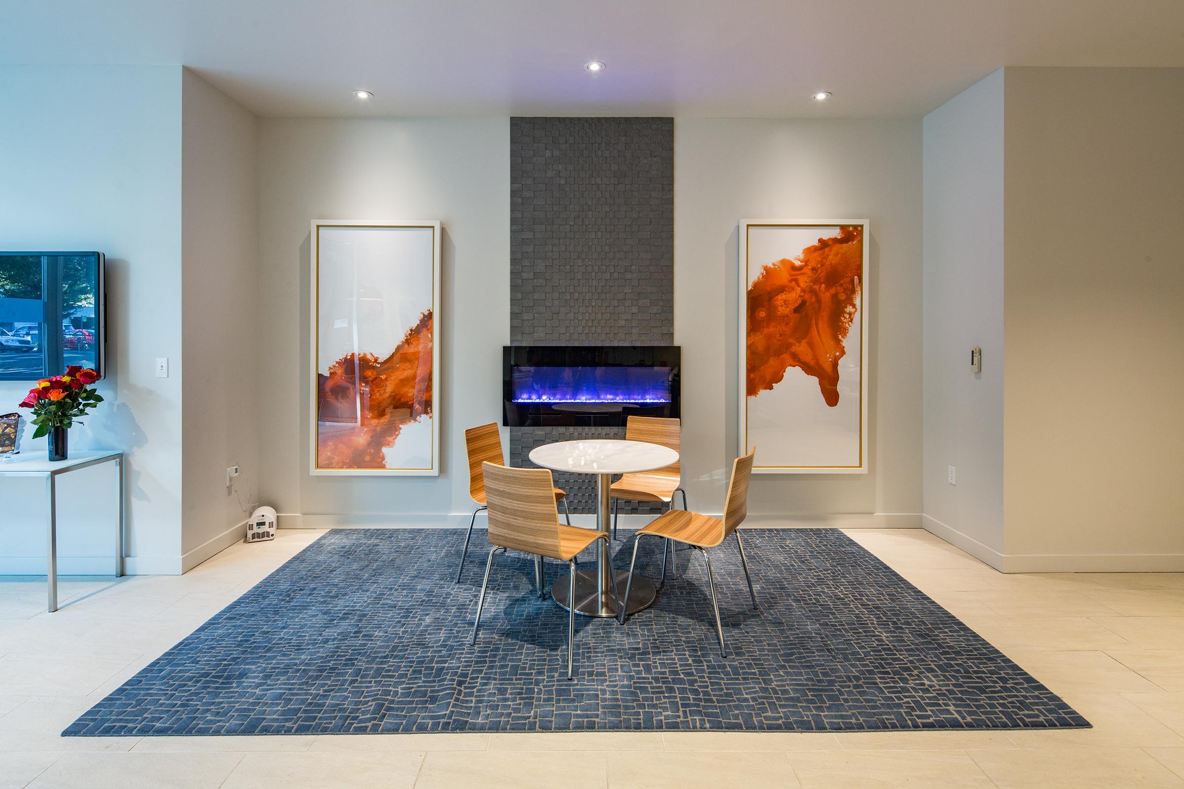 four seater round table in front of a television in the community lounge.