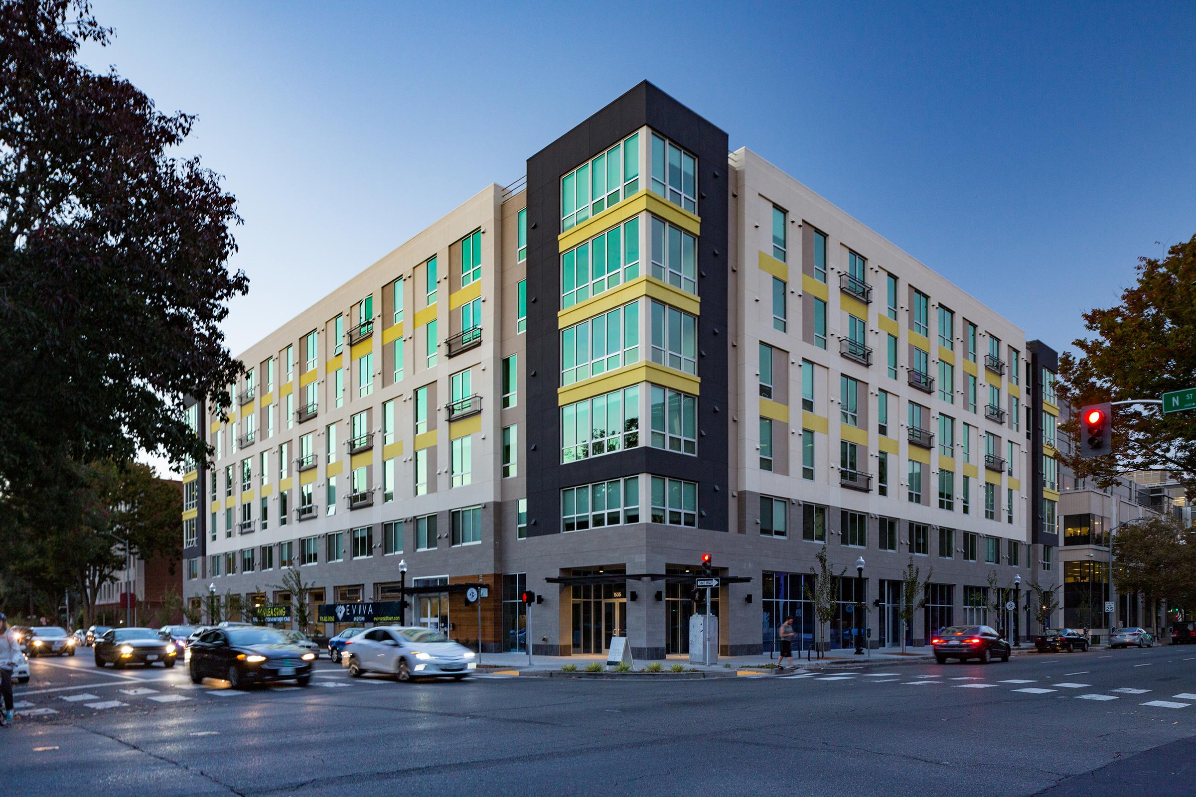 outside view of eviva midtown apartment homes at dusk.