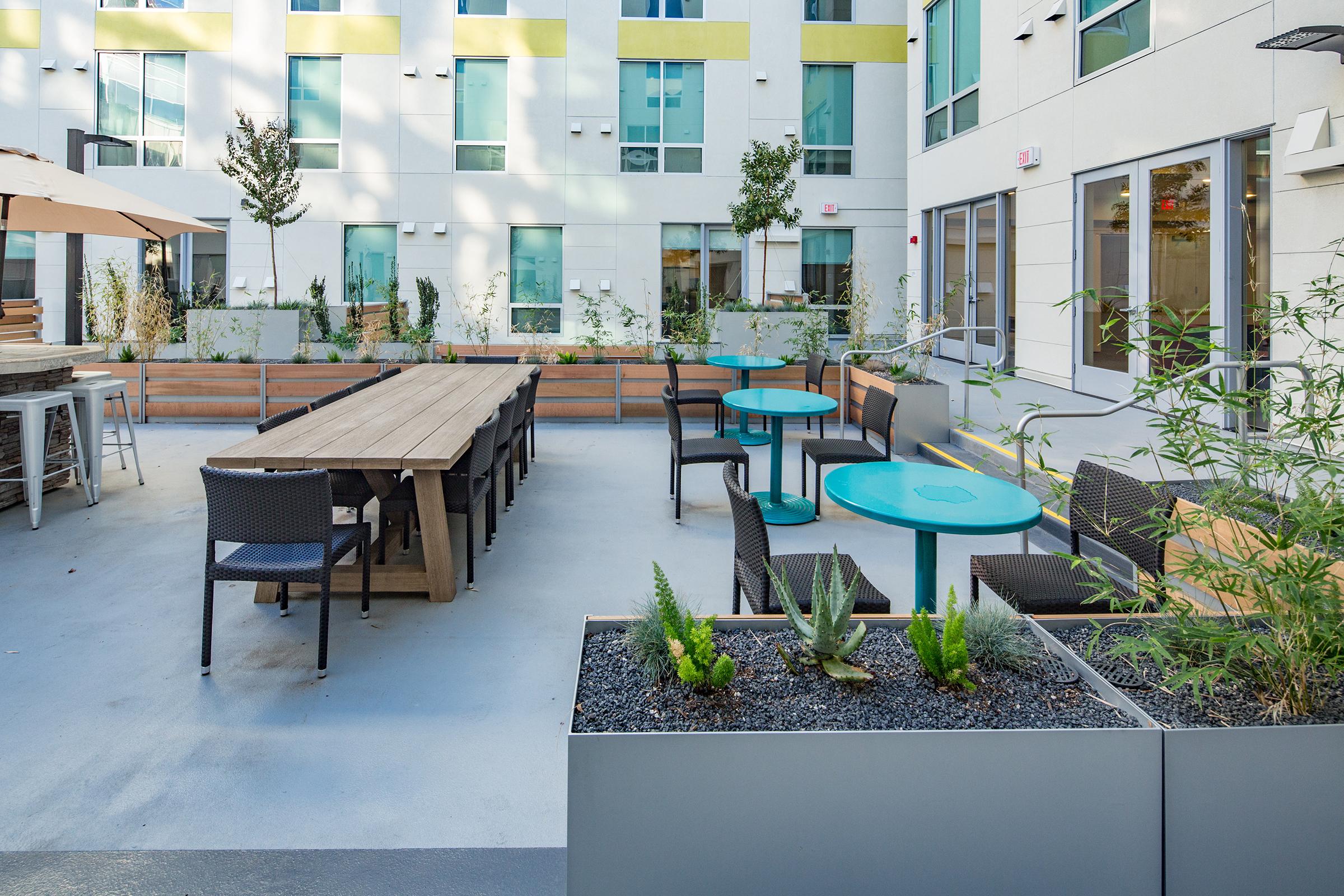 picnic and small round tables in the courtyard.