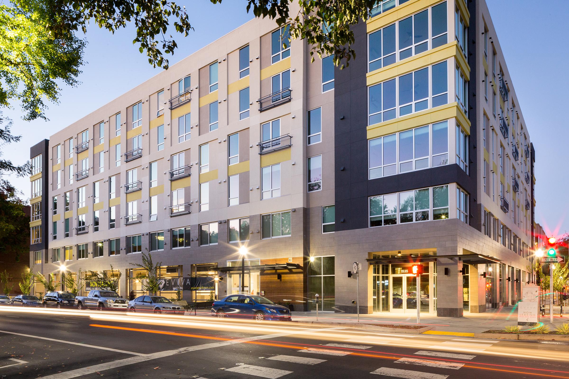 street view of apartment building at dusk.