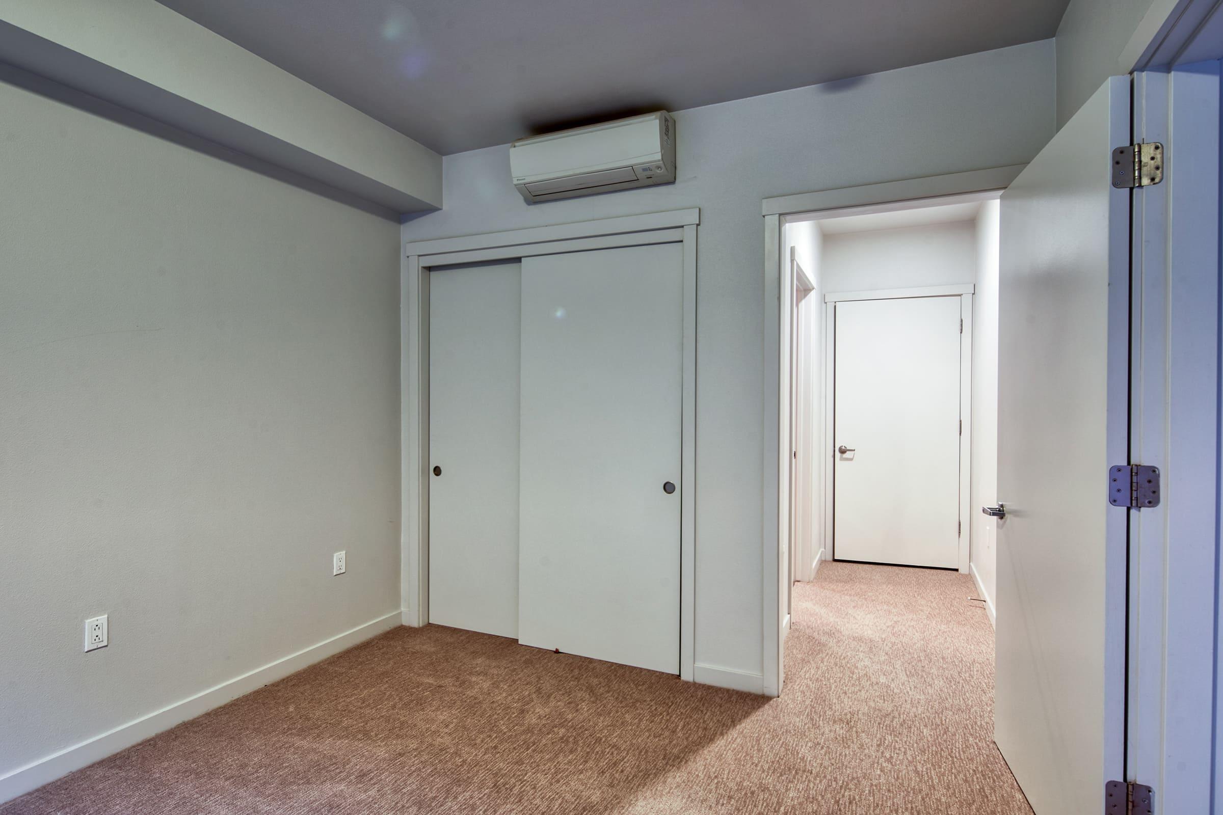 bedroom with plush carpeting and a closet.