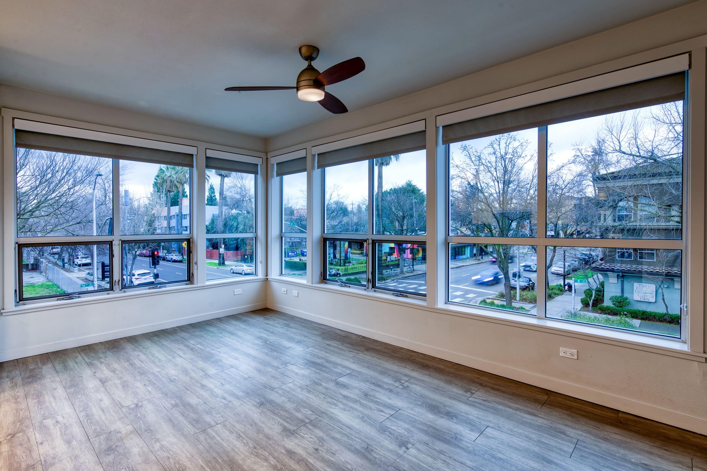 dining area with ceiling fan and over sized windows.