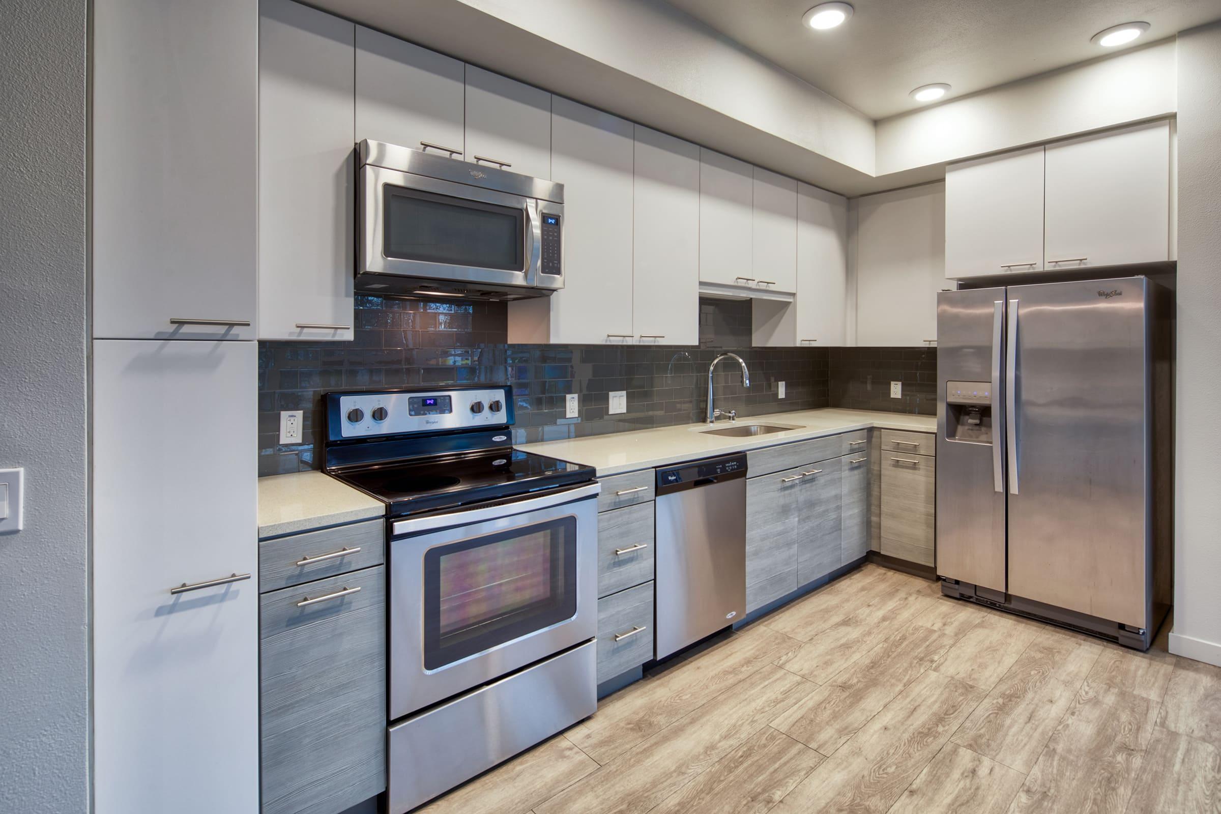 kitchen with stainless steel appliances and cabinets.